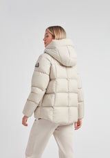 Woman wearing Cloud Prime Longline Down Puffer Jacket Stone, showcasing its stylish and functional design from the back.