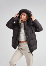 Cloud Prime Longline Down Puffer Jacket worn with adjustable hood and stylish urban outfit.