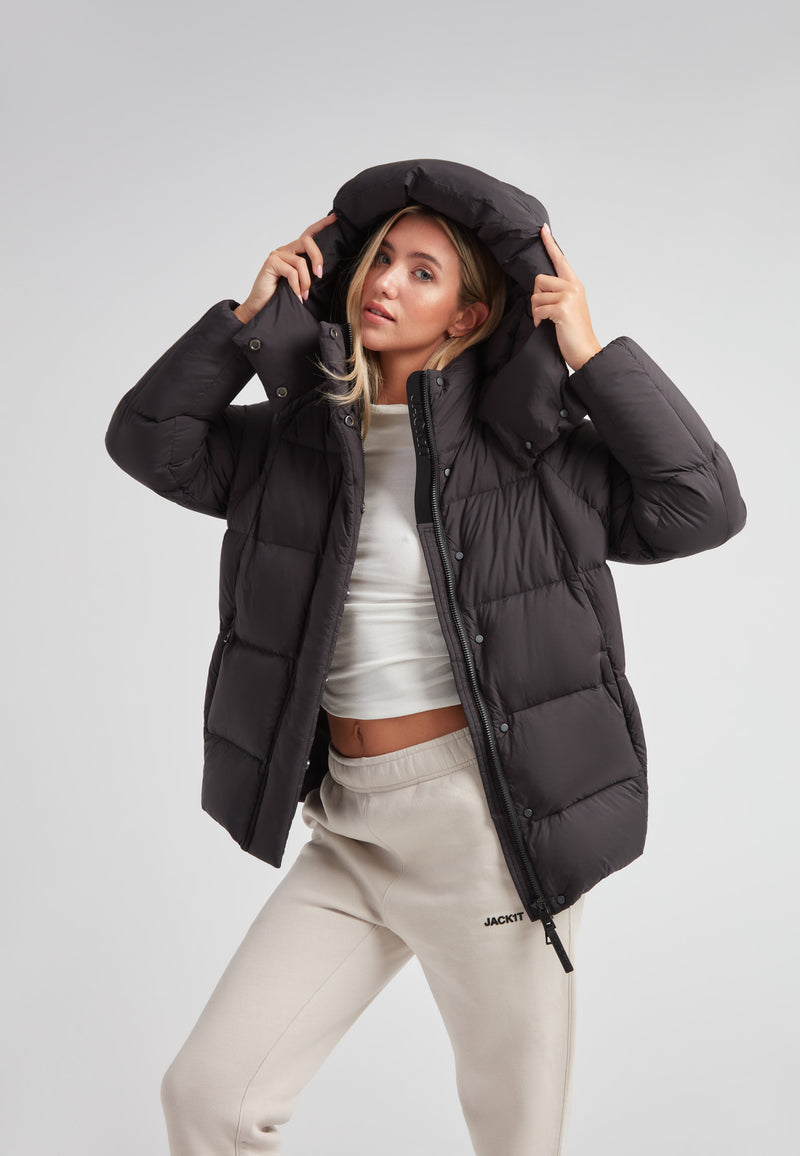 Cloud Prime Longline Down Puffer Jacket worn with adjustable hood and stylish urban outfit.