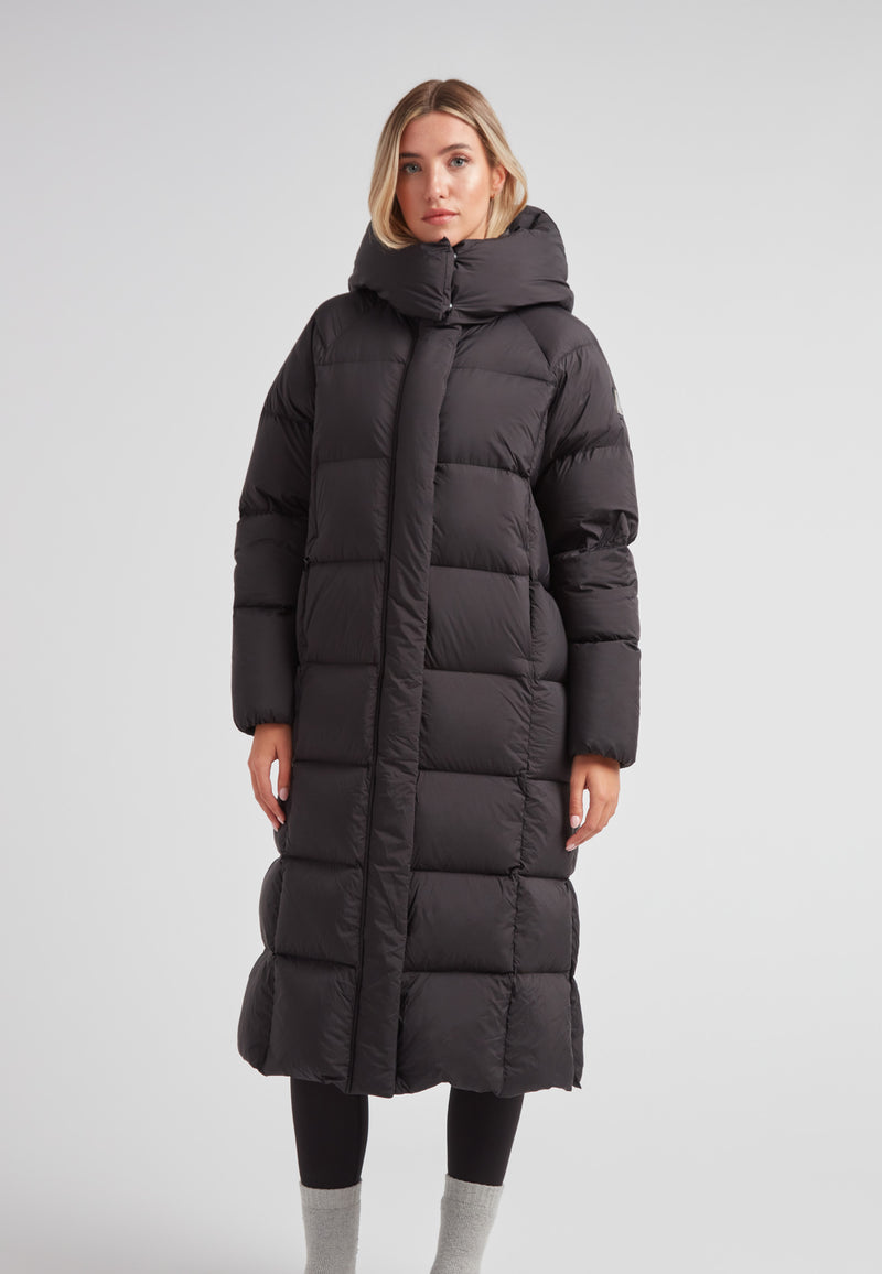 Model wearing a Long puffer jacket in black, featuring an adjustable hood and ankle-length design.