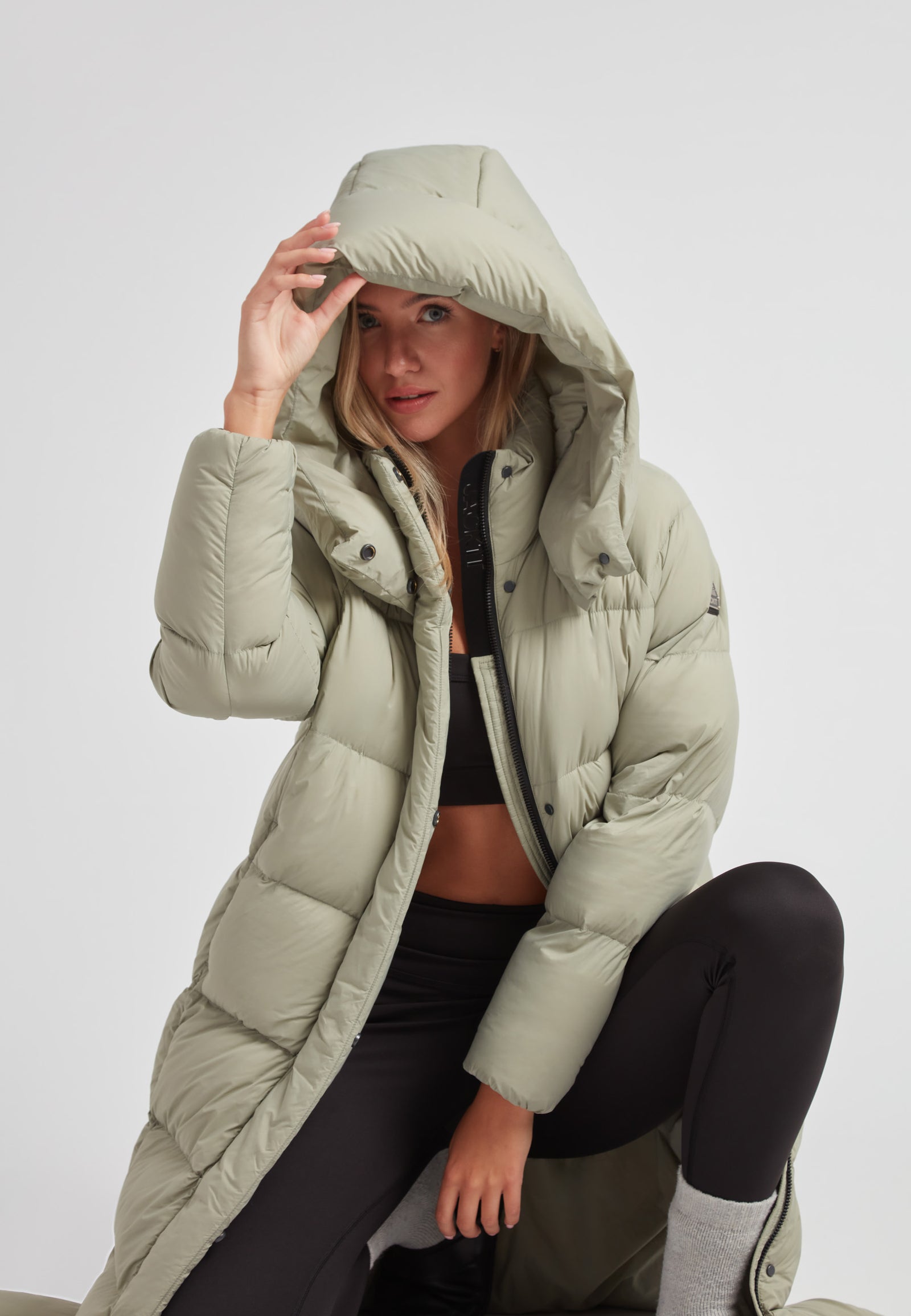 Model wearing a Cloud Ultra Long Down Puffer Coat with a hood, showcasing style and warmth.