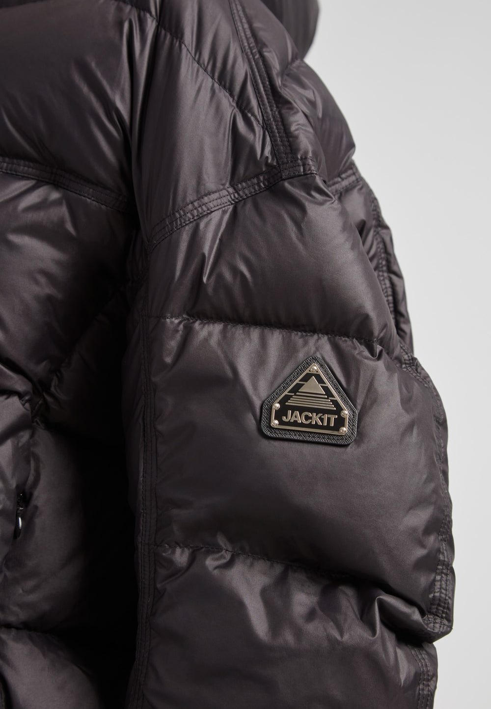 Close-up of the Cloud Boss Down Puffer Jacket, a cropped puffer in black with adjustable coverage.