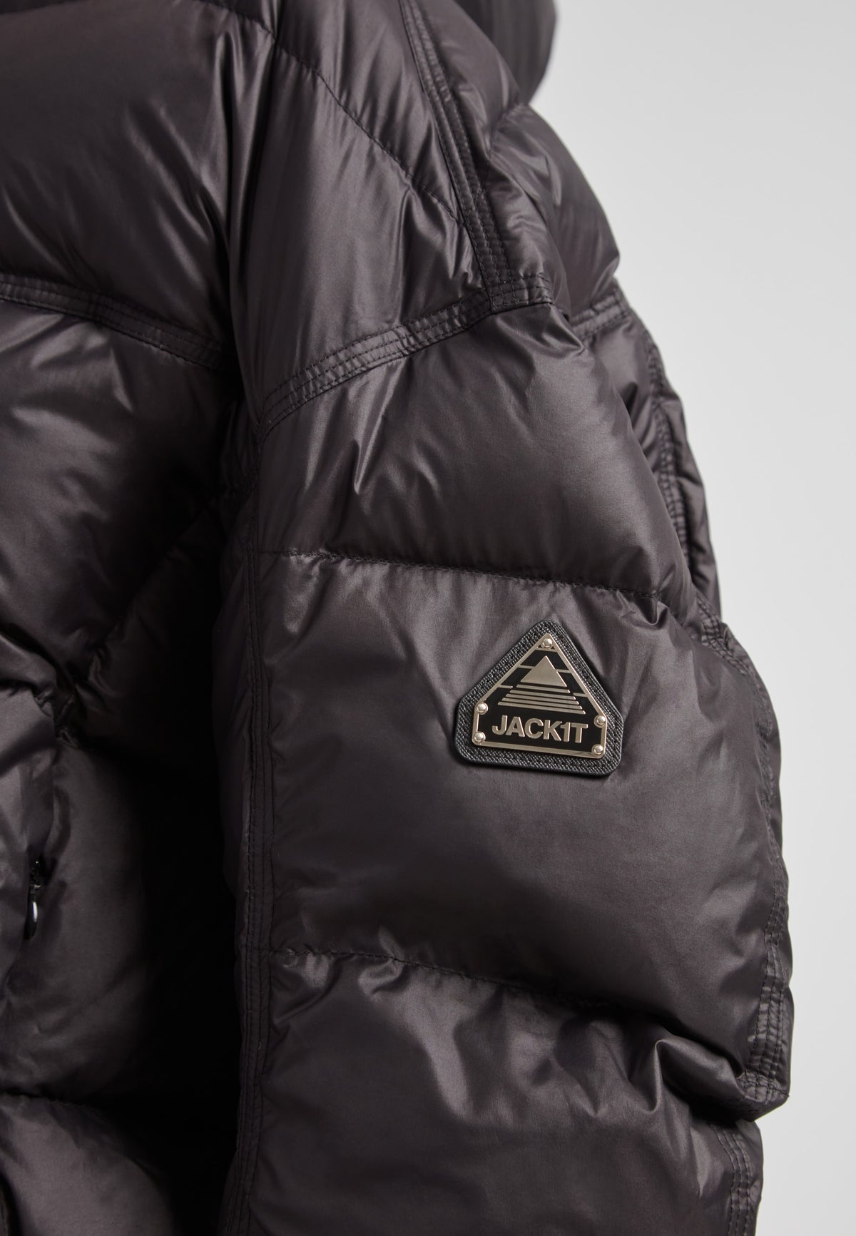 Close-up of the Cloud Boss Down Puffer Jacket, a cropped puffer in black with adjustable coverage.