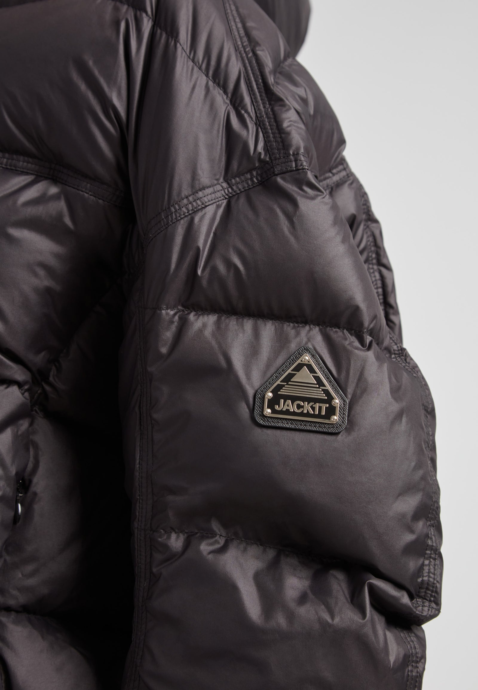 Close-up of the Cloud Boss Down Puffer Jacket, a cropped puffer in black with adjustable coverage.