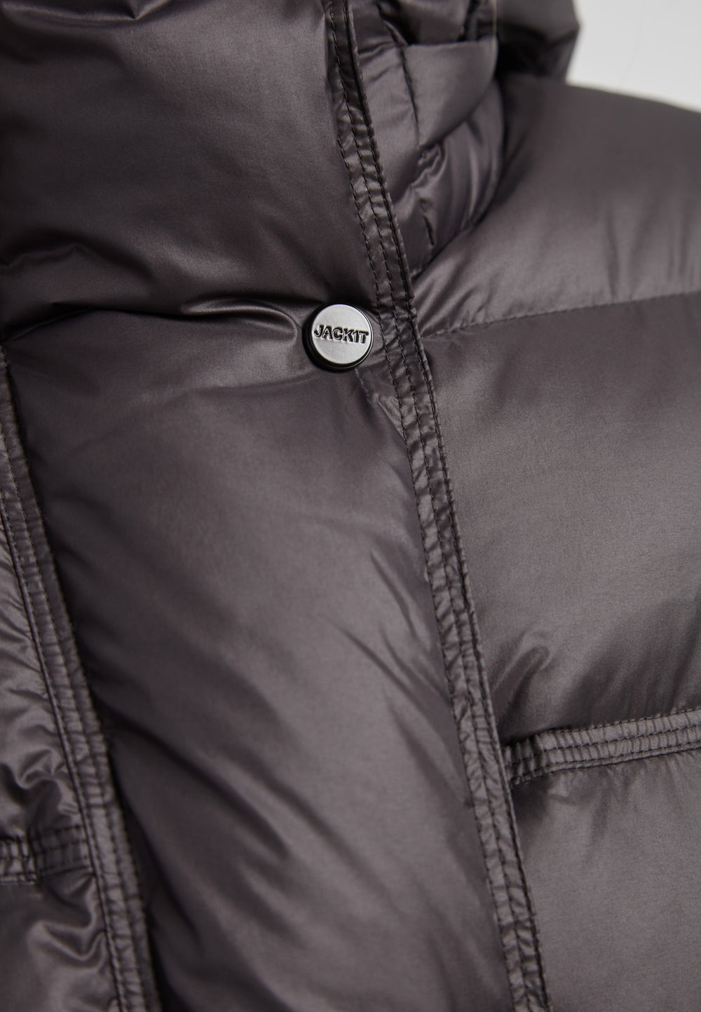 Close-up of the Cloud Boss cropped puffer in black with adjustable coverage showcasing the jacket's texture and detail.