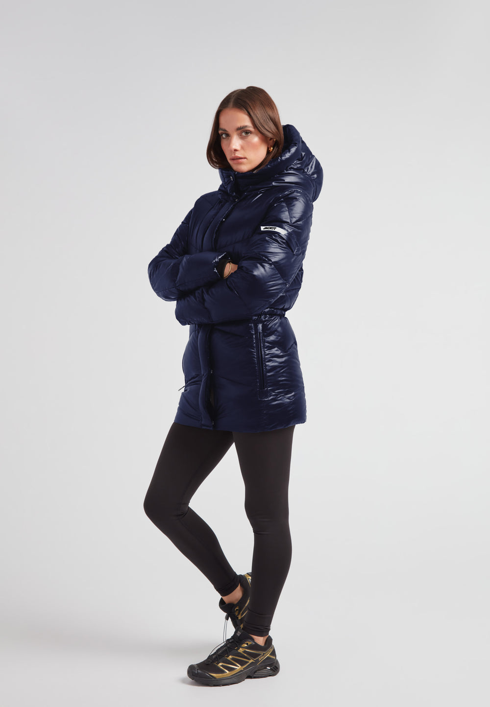 Womens navy down puffer coat with hood, mid-length, and water repellent shell, designed for everyday wear.