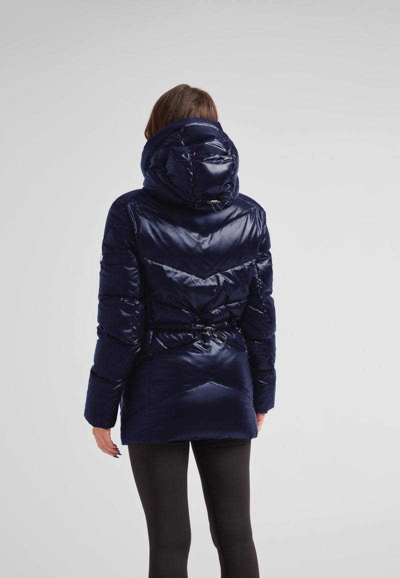 Back view of a woman wearing a Womens navy down puffer coat with adjustable waist and hood.