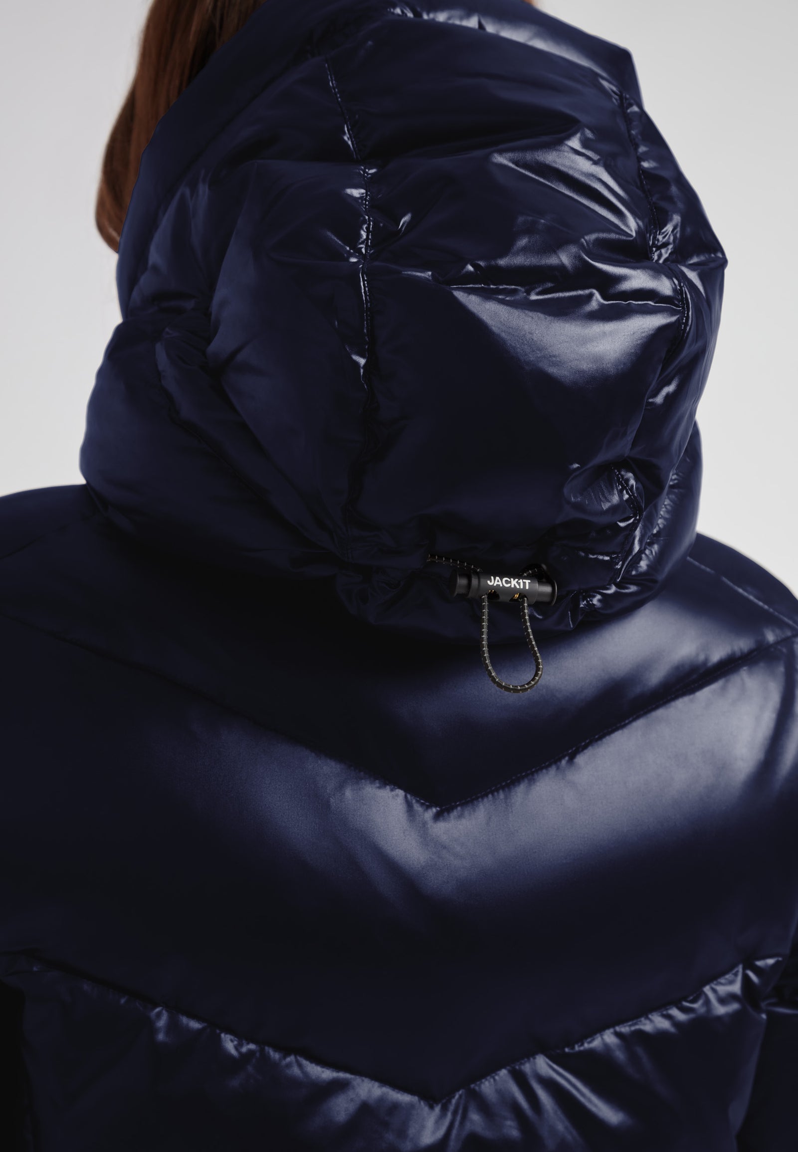 Womens navy down puffer coat featuring a hood and sleek water-repellent design for warmth and style.