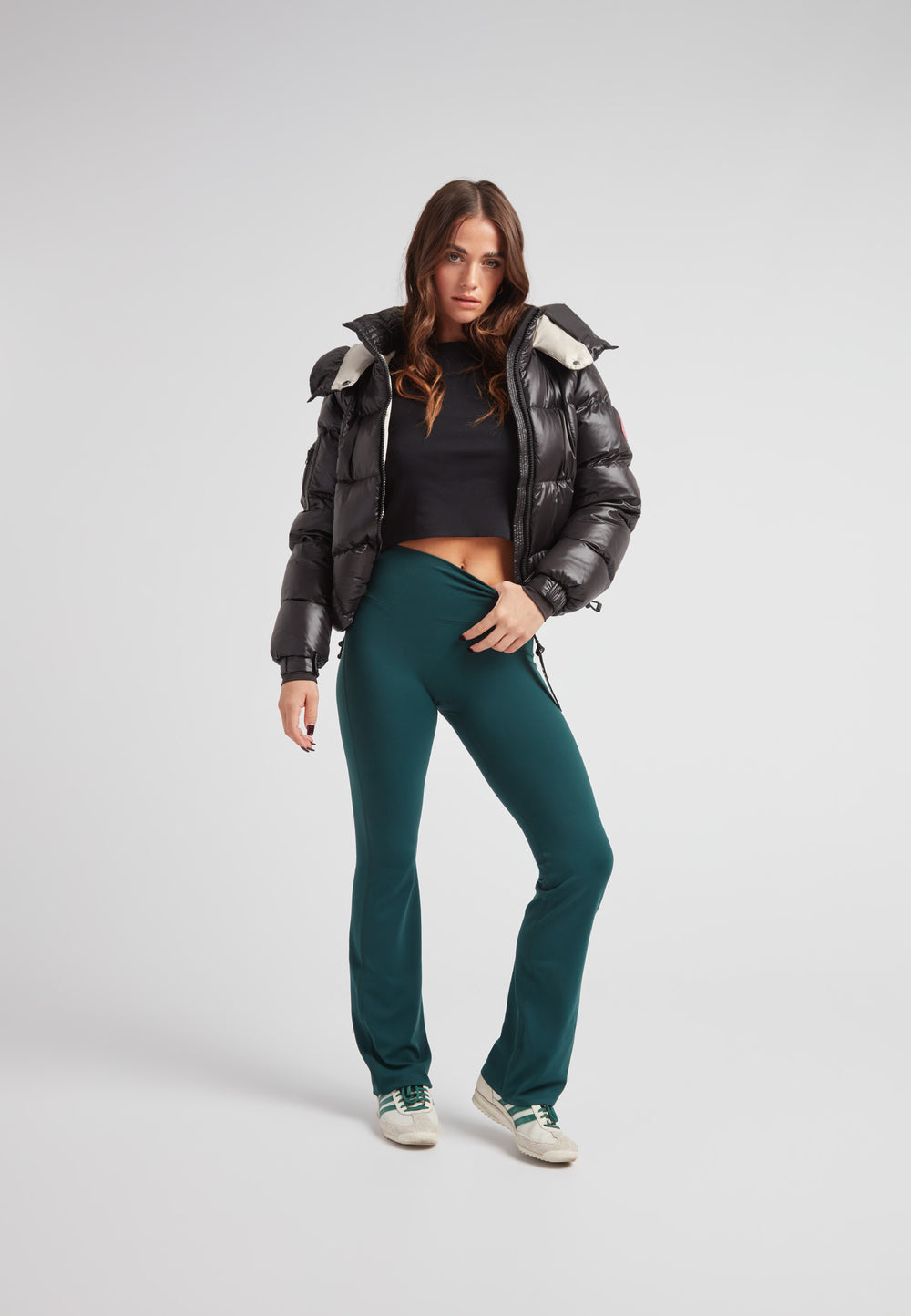 Model wearing EZ Boxed Crop Down Puffer Jacket Lux Black with green pants and sneakers.