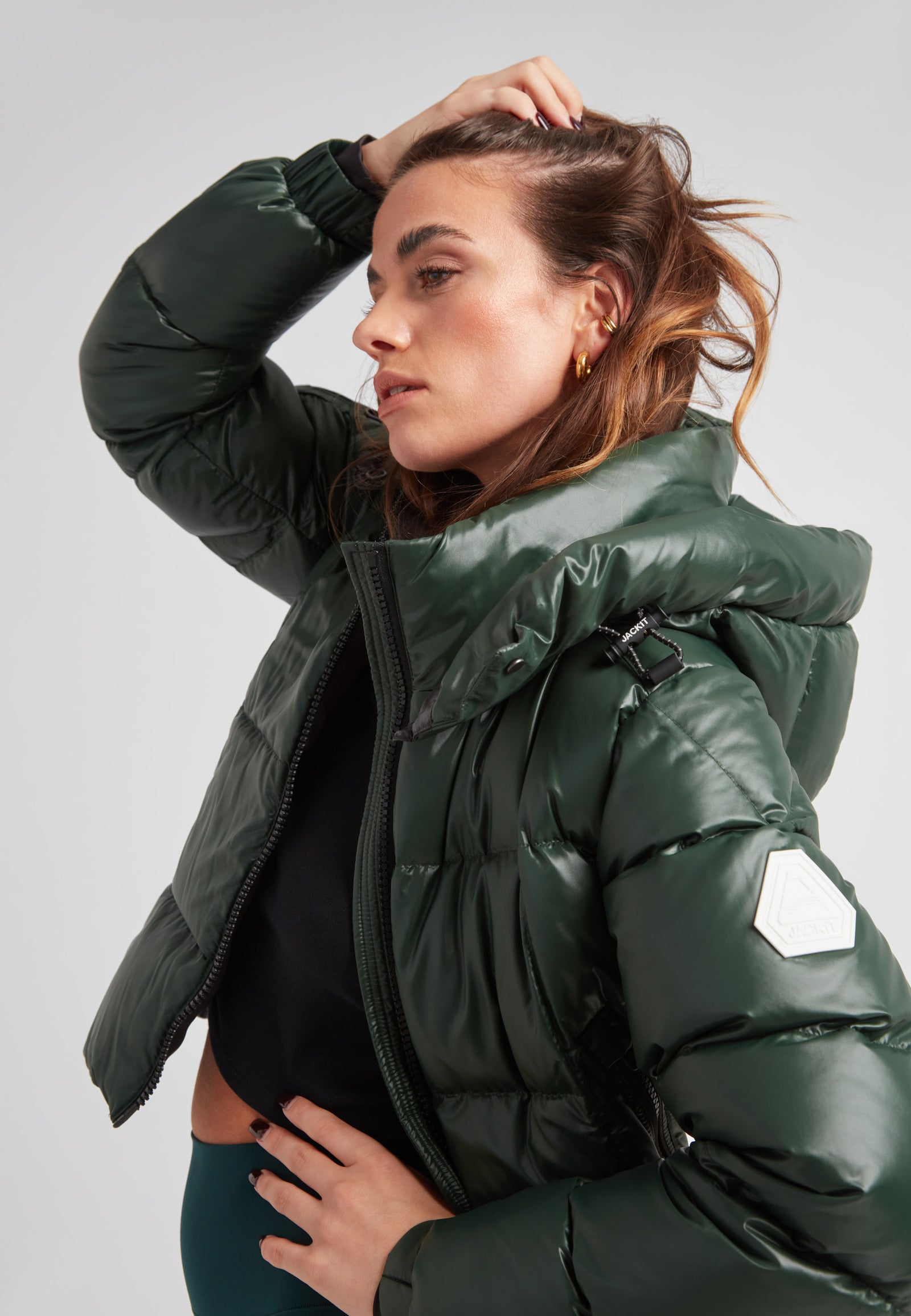 Model wearing the EZ Boxed Crop Down Puffer Jacket Lux Emerald, showcasing its stylish design and warmth.