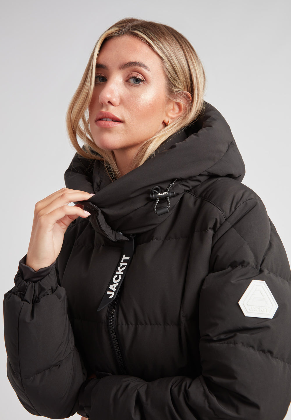 Model wearing the EZ Boxed Racer Down Puffer Jacket Matt Black with adjustable hood and sleek design.