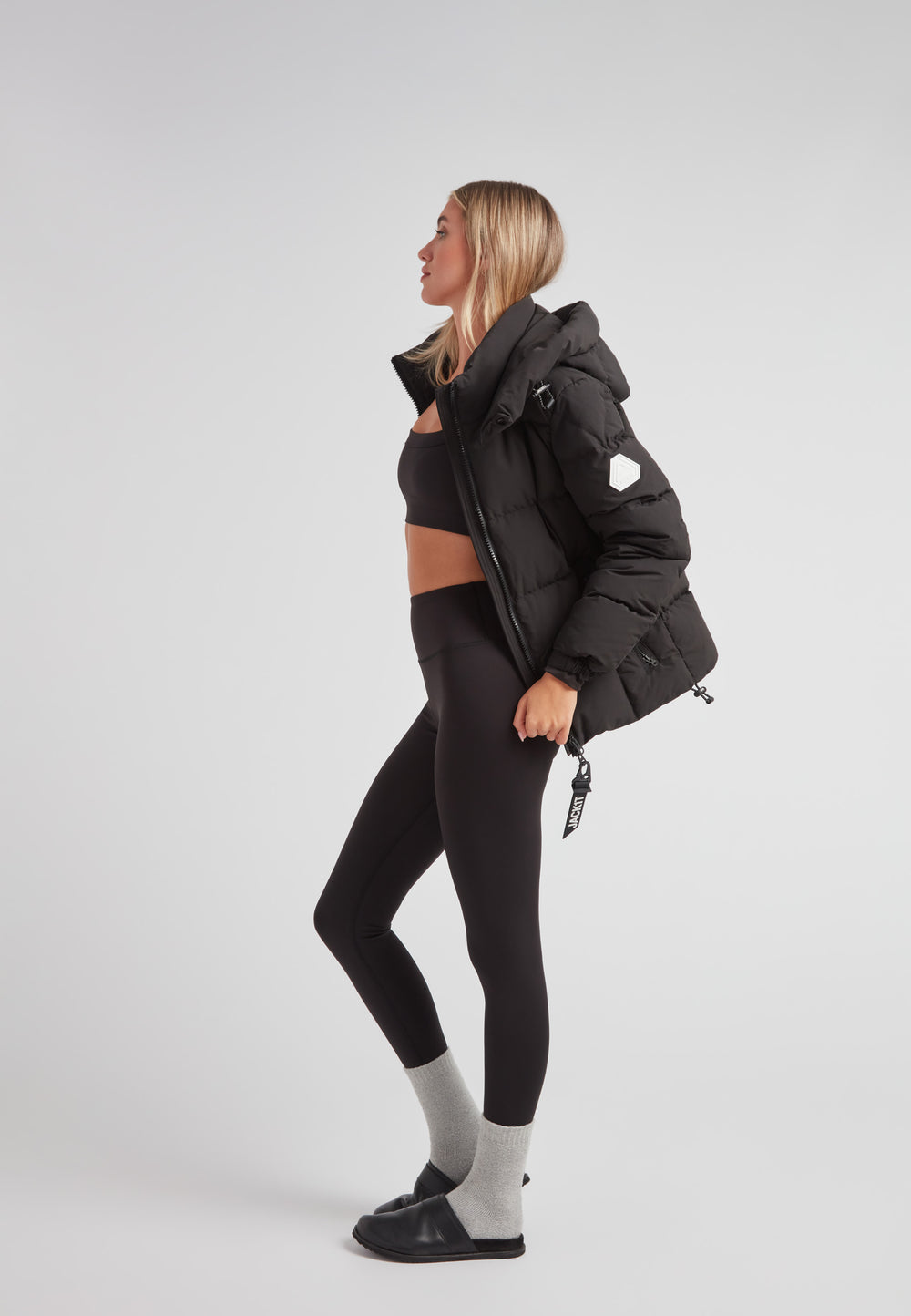 EZ Boxed Racer Down Puffer Jacket Matt Black worn by a model with stylish leggings and a cropped top.