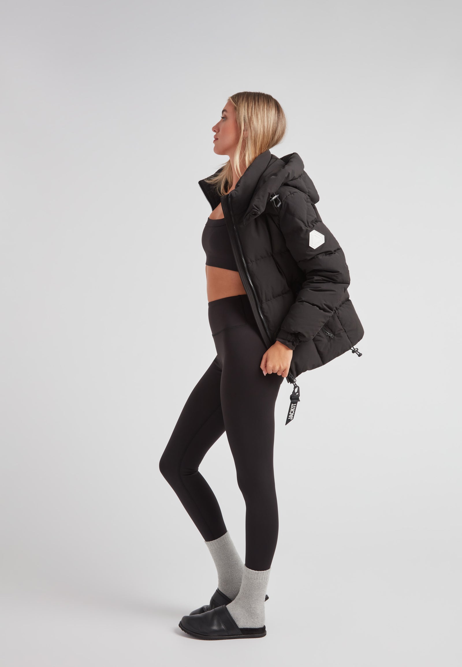 EZ Boxed Racer Down Puffer Jacket Matt Black worn by a model with stylish leggings and a cropped top.