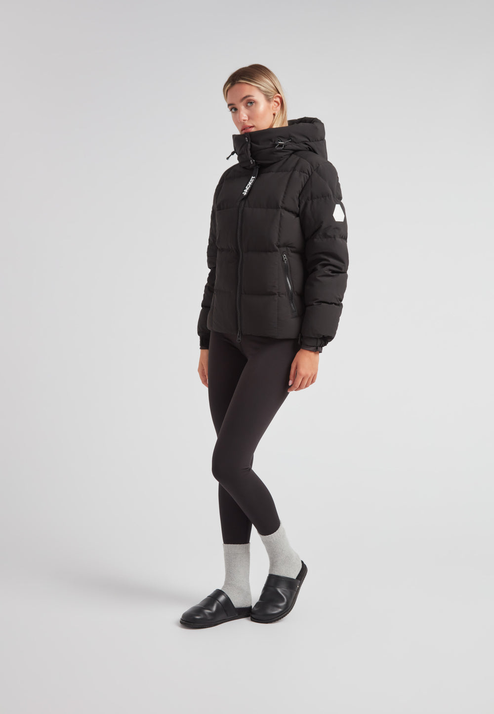 Model wearing EZ Boxed Racer Down Puffer Jacket Matt Black, featuring cropped silhouette and adjustable hood.