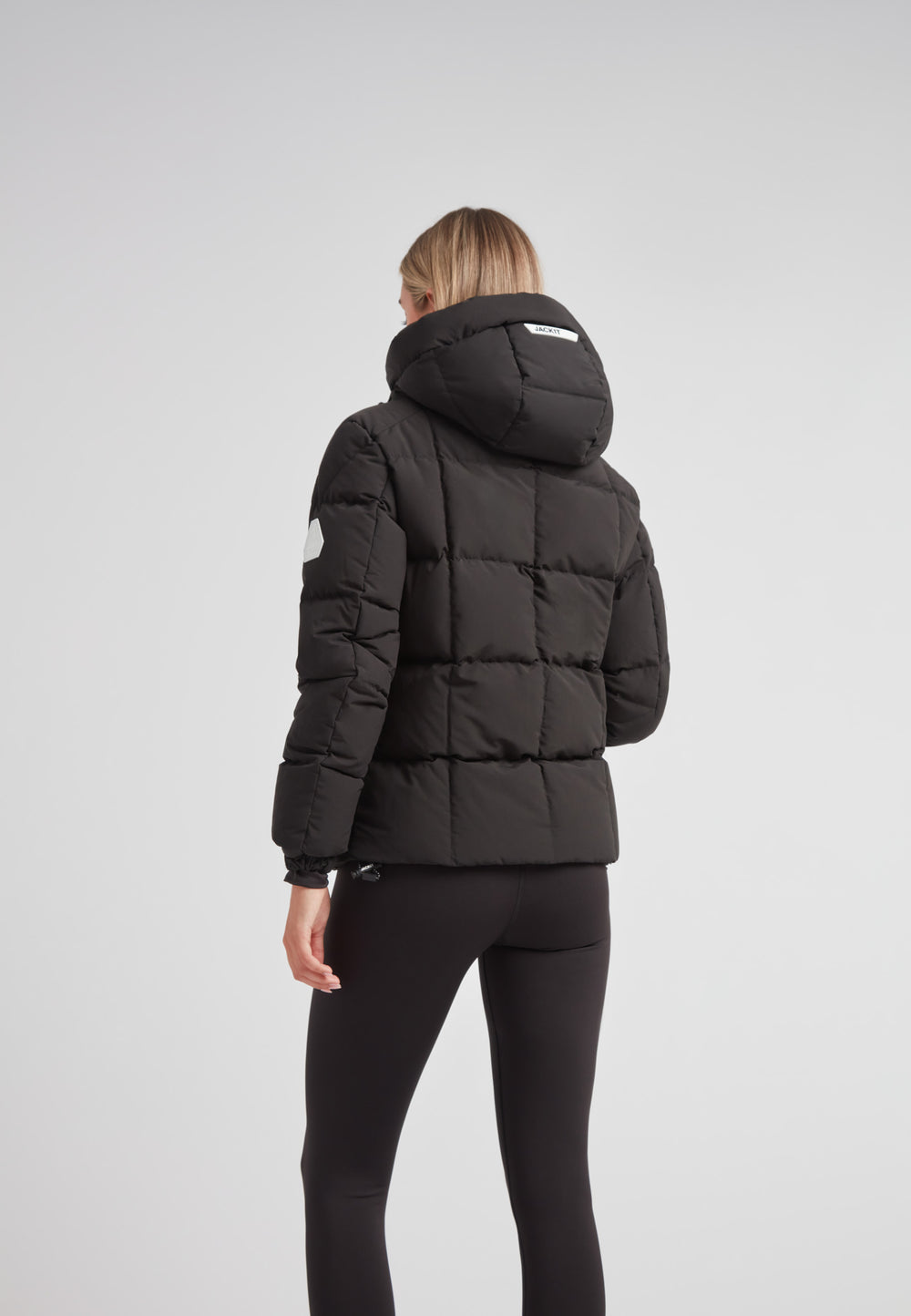 EZ Boxed Racer Down Puffer Jacket Matt Black worn by model from the back, showcasing cropped silhouette and adjustable hood.