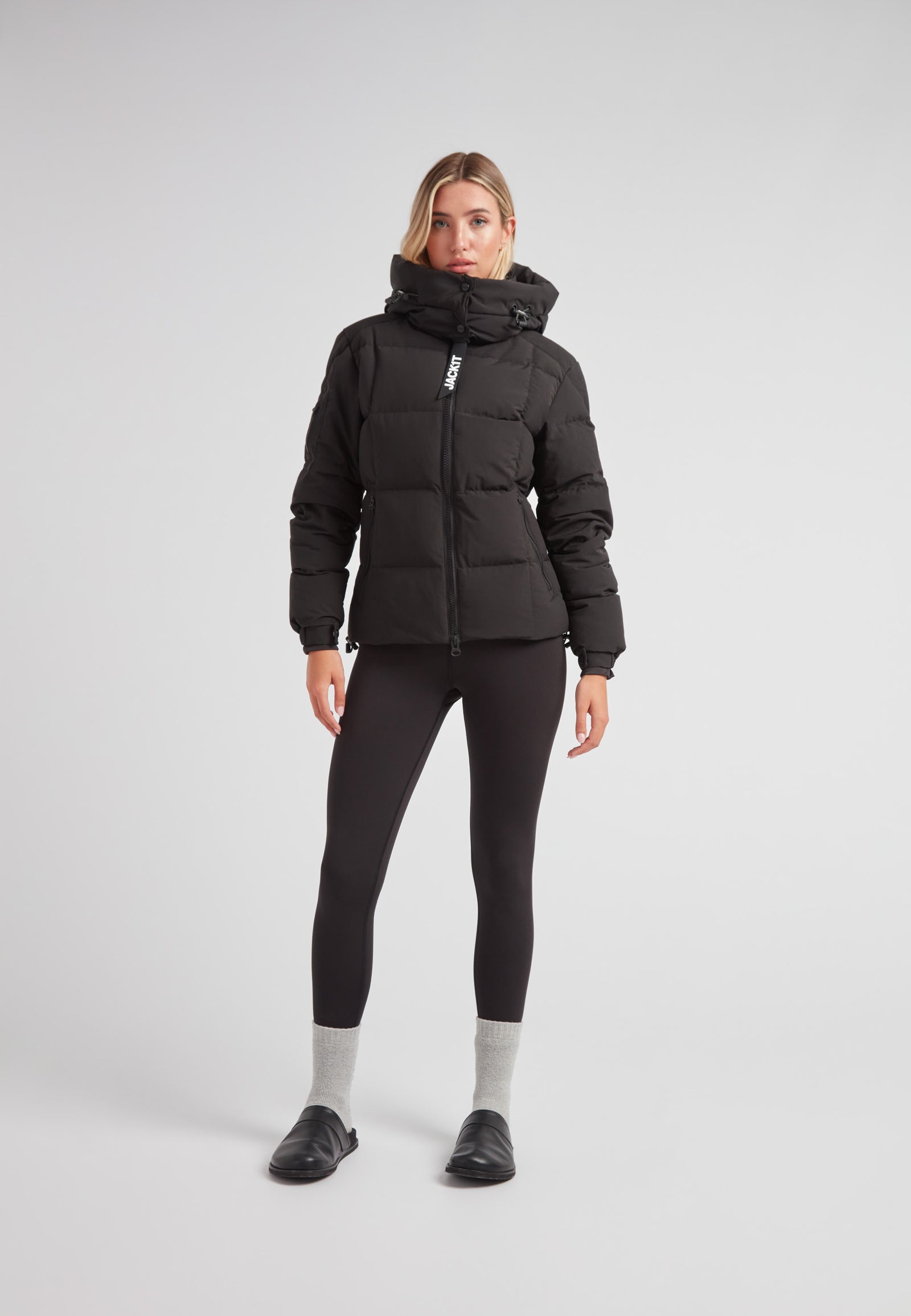 EZ Boxed Racer Down Puffer Jacket Matt Black worn by a model with leggings and sleek footwear.