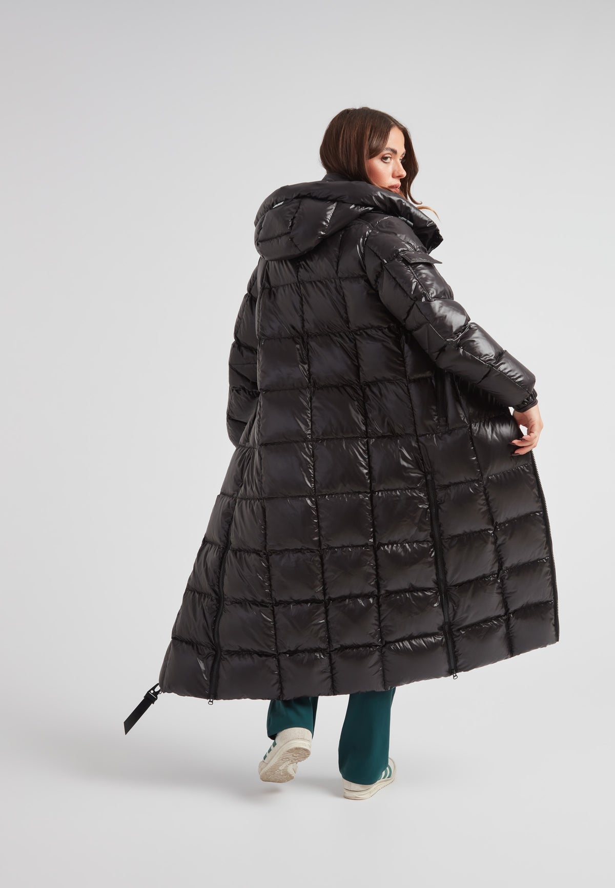 Woman wearing the EZ Boxed Ultra Long Down Puffer Coat Lux Black, showcasing its stylish back view and long design.