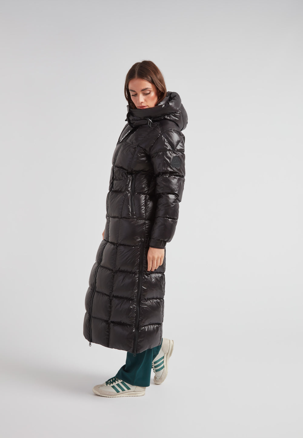 Woman wearing the EZ Boxed Ultra Long Down Puffer Coat Lux Black in a stylish pose.