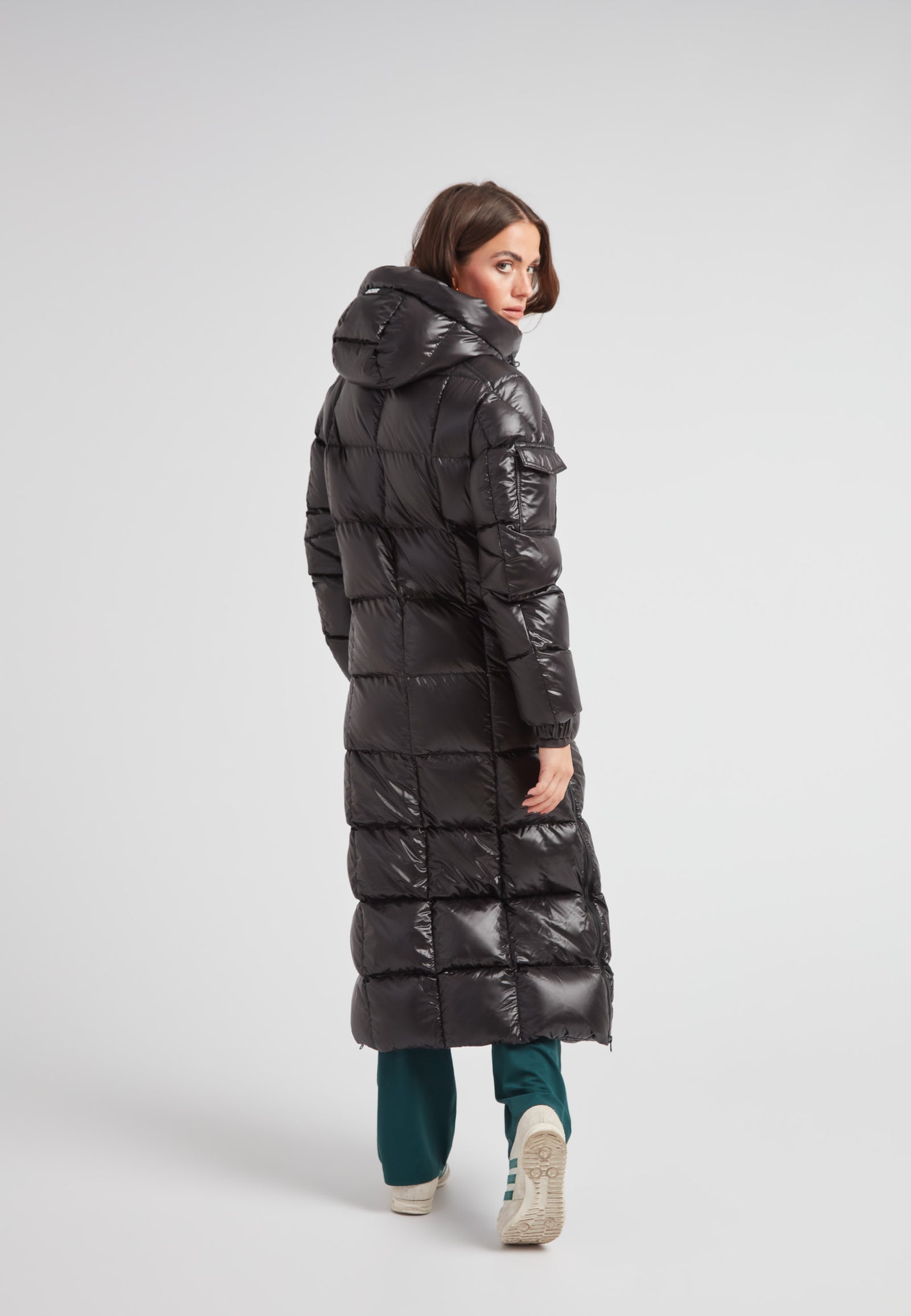 Woman wearing the EZ Boxed Ultra Long Down Puffer Coat Lux Black from the back, showcasing its sleek design and long length.