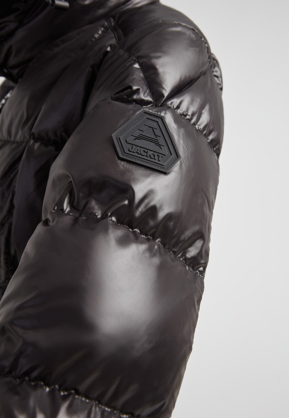 Close-up of EZ Boxed Ultra Long Down Puffer Coat Lux Black showing sleek fabric and logo detail.
