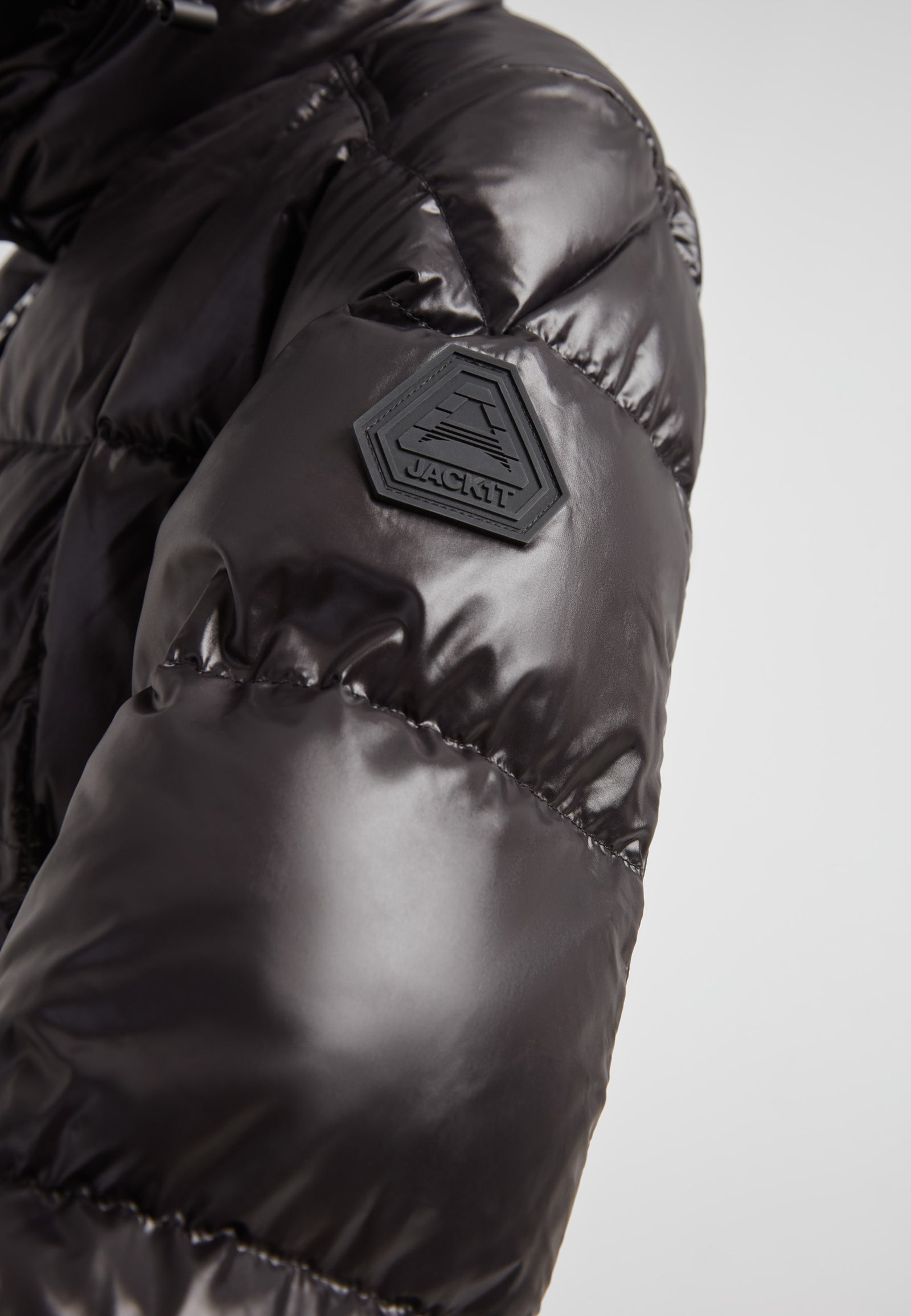 Close-up of EZ Boxed Ultra Long Down Puffer Coat Lux Black showing sleek fabric and logo detail.