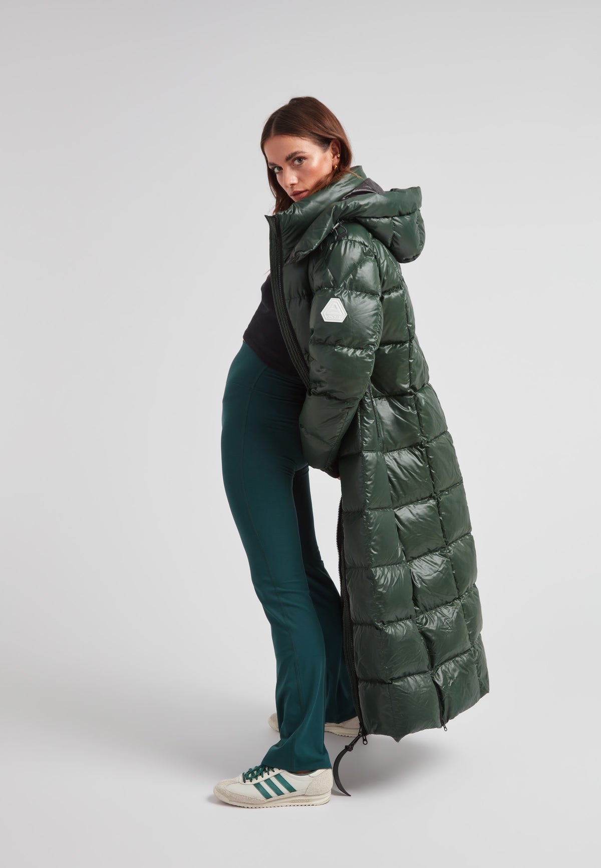 Model showcasing the EZ Boxed Ultra Long Down Puffer Coat Lux Emerald, highlighting its stylish design and warmth.