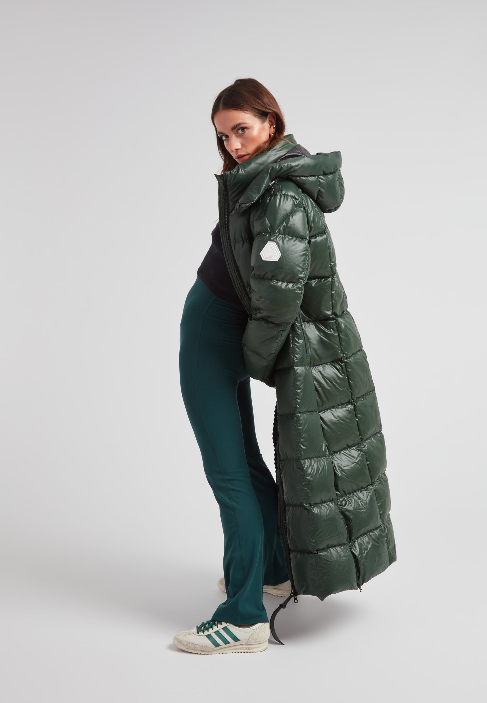 Model showcasing the EZ Boxed Ultra Long Down Puffer Coat Lux Emerald, highlighting its stylish design and warmth.
