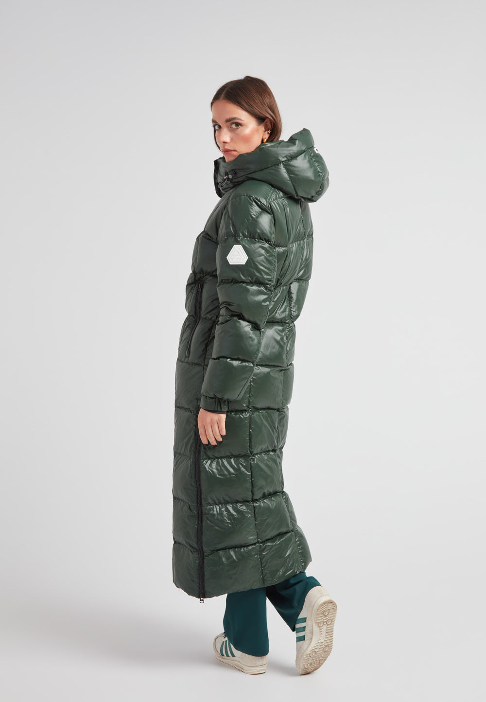 Model wearing the EZ Boxed Ultra Long Down Puffer Coat Lux Emerald, showcasing its sleek design and long silhouette.