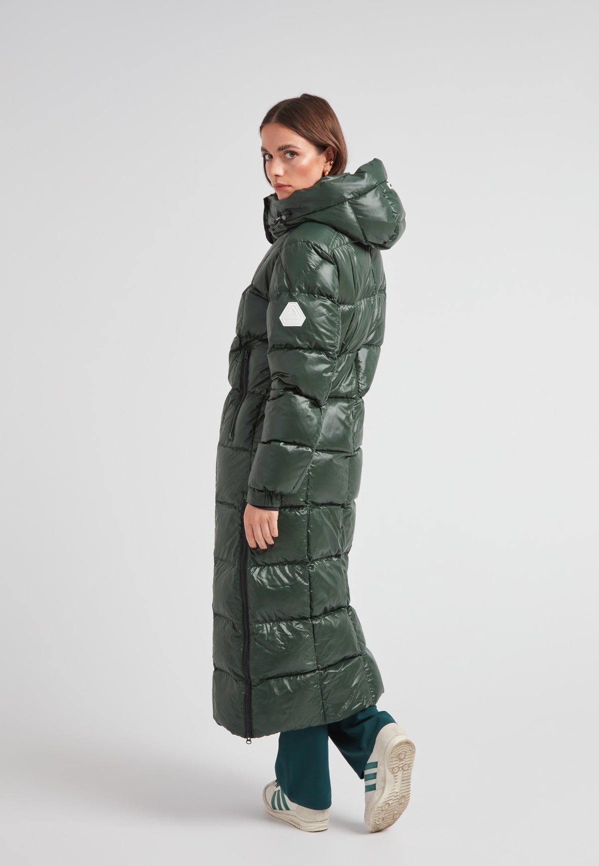 Model wearing the EZ Boxed Ultra Long Down Puffer Coat Lux Emerald, showcasing its sleek design and long silhouette.