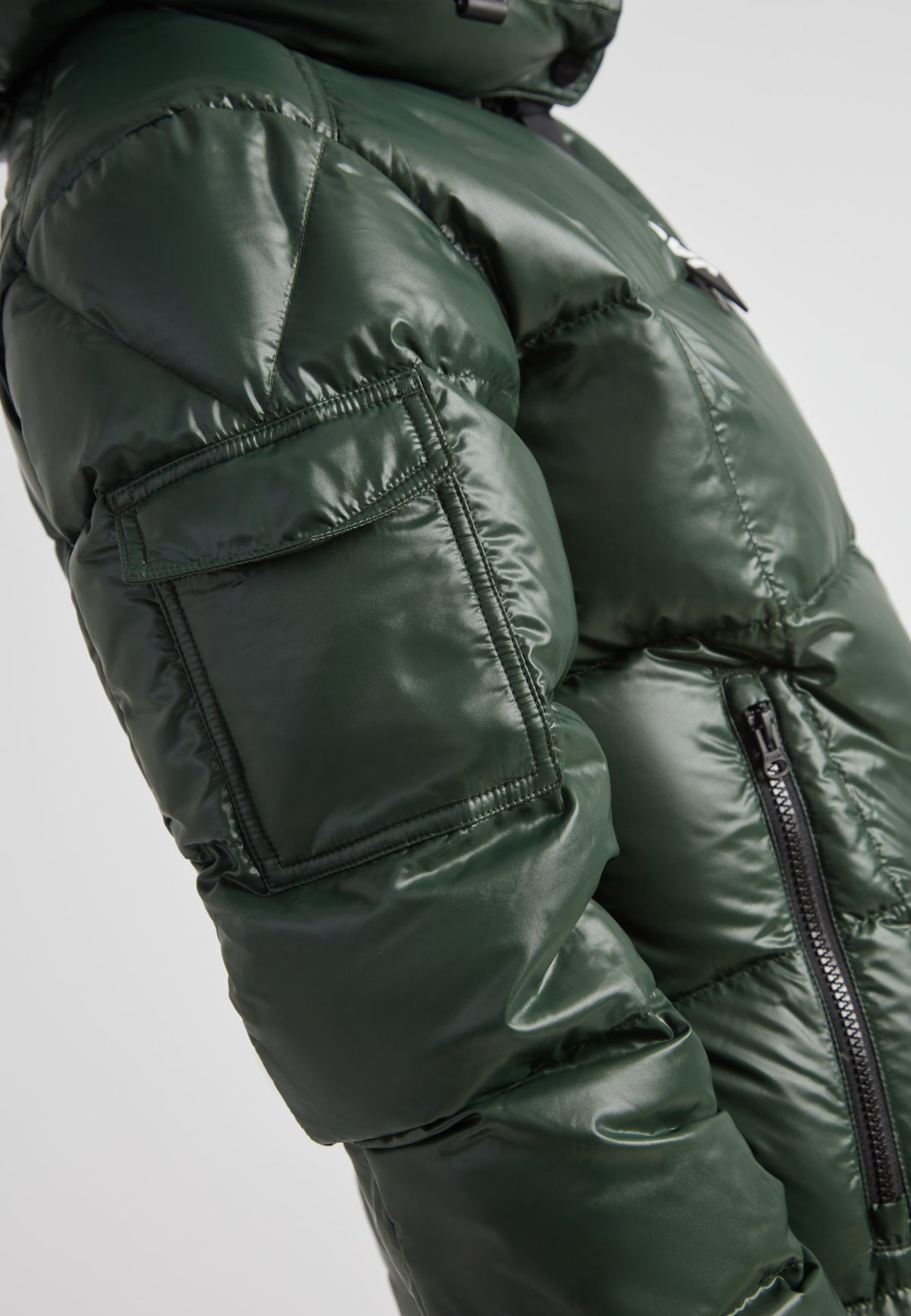 EZ Boxed Ultra Long Down Puffer Coat Lux Emerald close-up side view showcasing its sleek design and functionality.