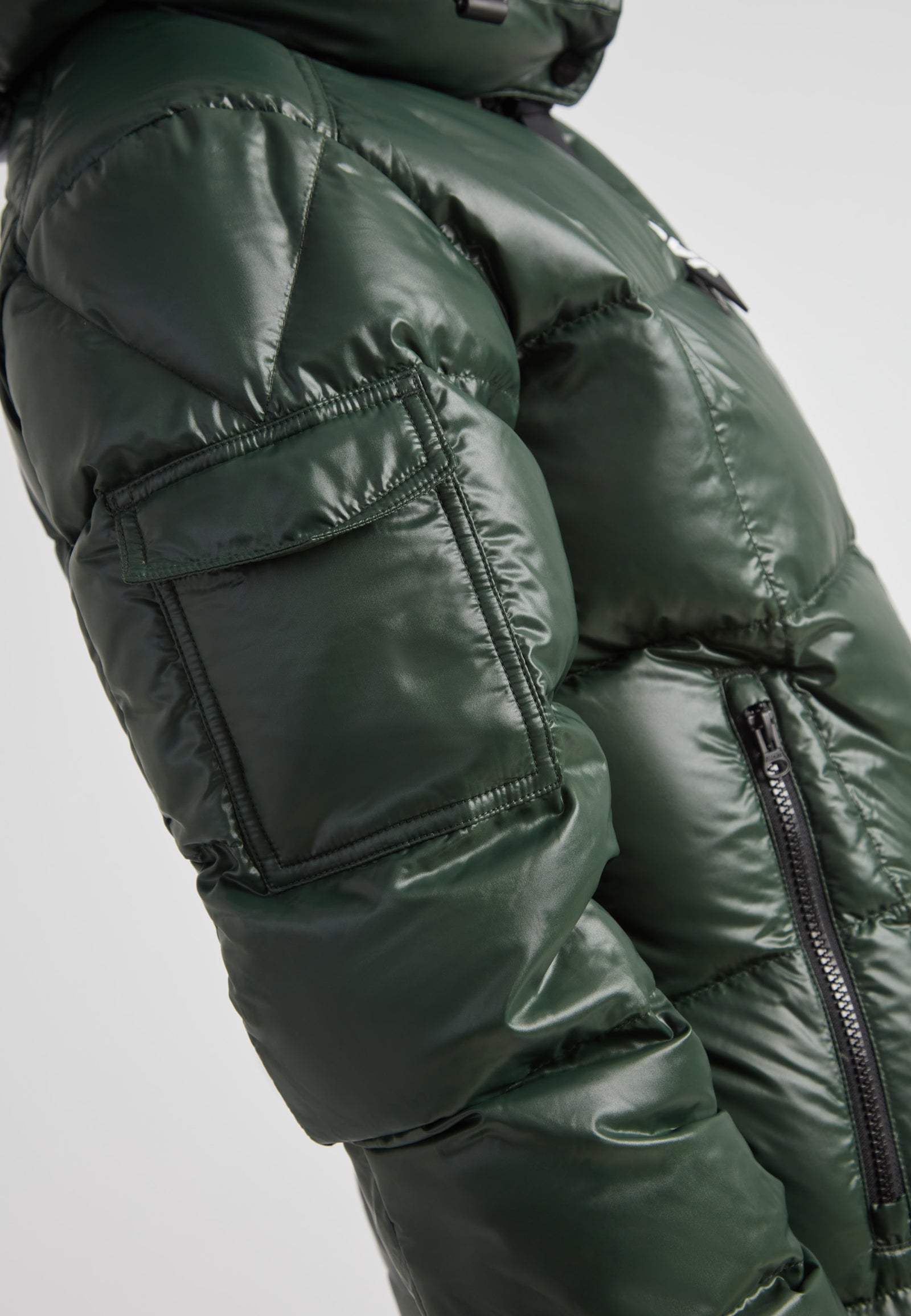 EZ Boxed Ultra Long Down Puffer Coat Lux Emerald close-up side view showcasing its sleek design and functionality.