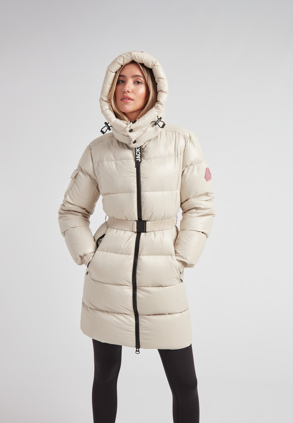 Woman wearing the EZ Belted Down Puffer Coat Lux Stone, showcasing its stylish design and functional details.