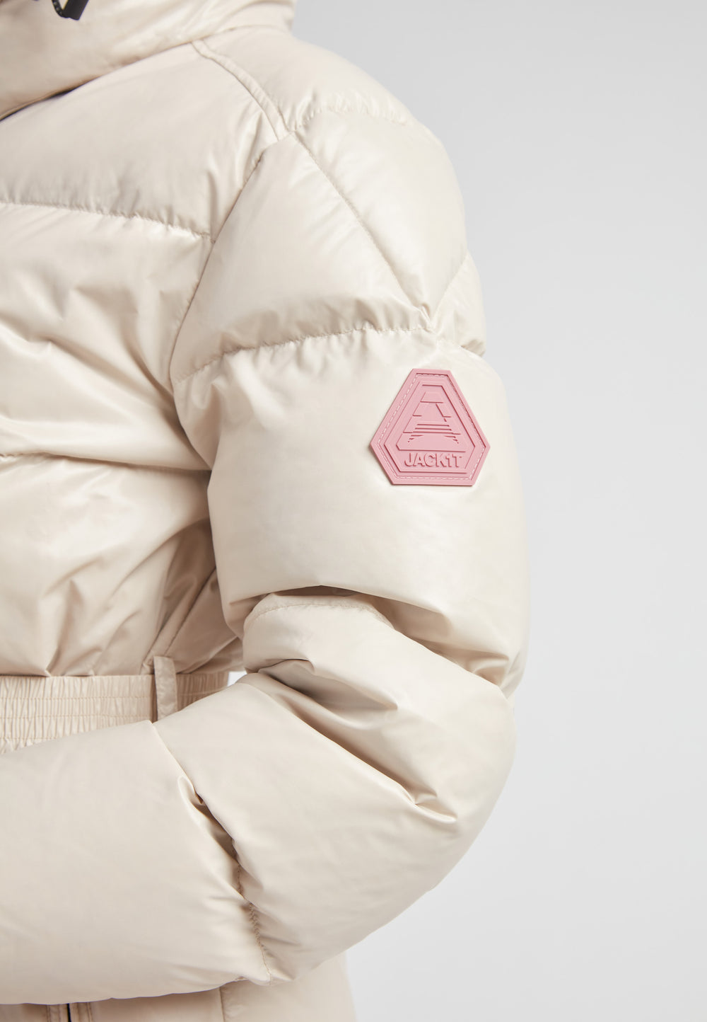 EZ Belted Down Puffer Coat Lux Stone featuring a smooth matte shell and stylish arm patch detail.