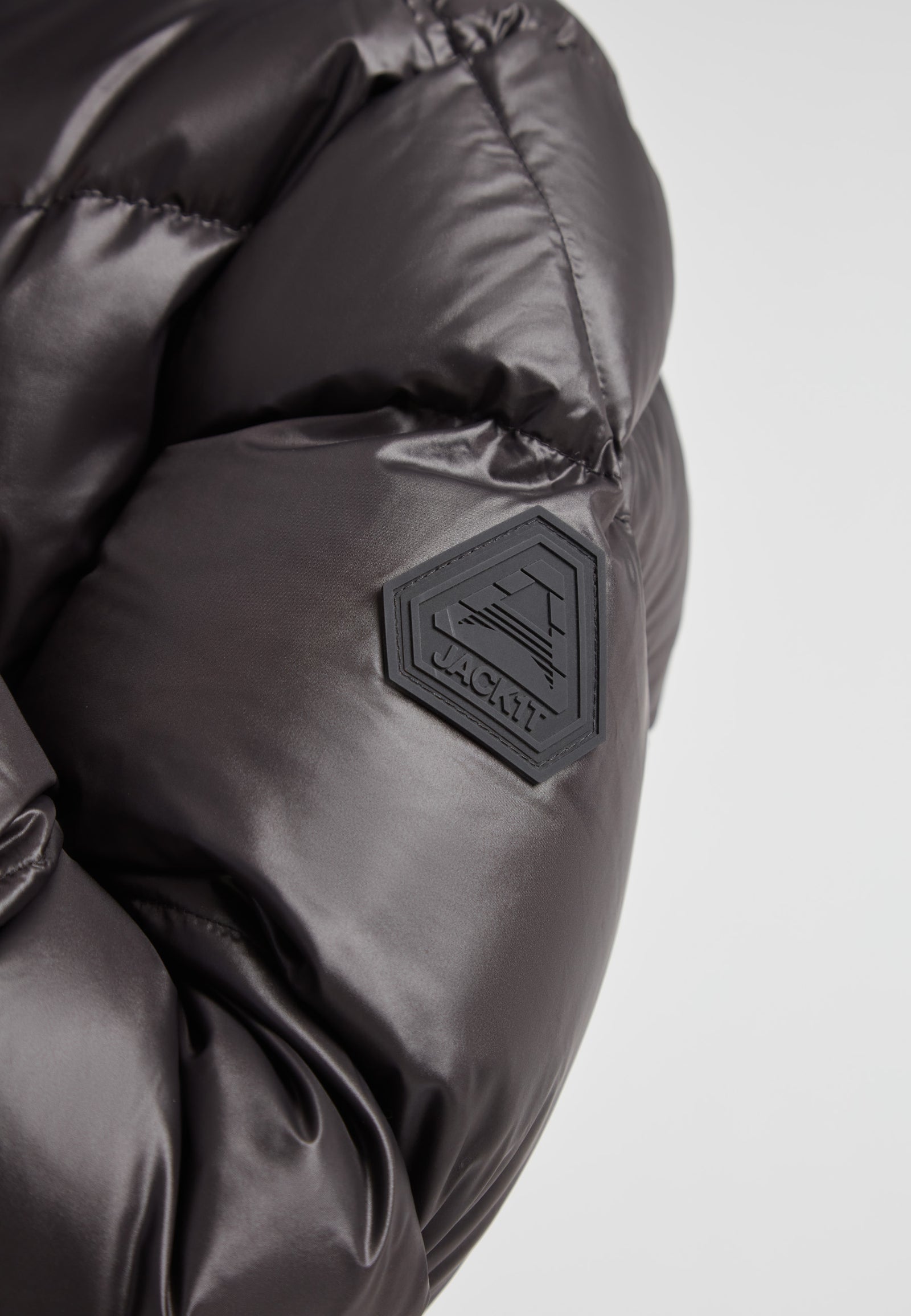 Close-up of EZ Belted Down Puffer Coat Lux Black showing the durable fabric and logo detail.