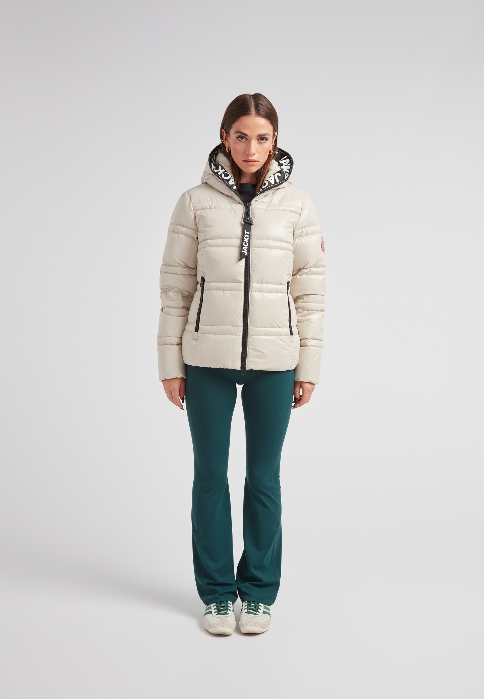 R4D Tramline puffer racer jacket lux stone worn by a model with green pants and white sneakers.