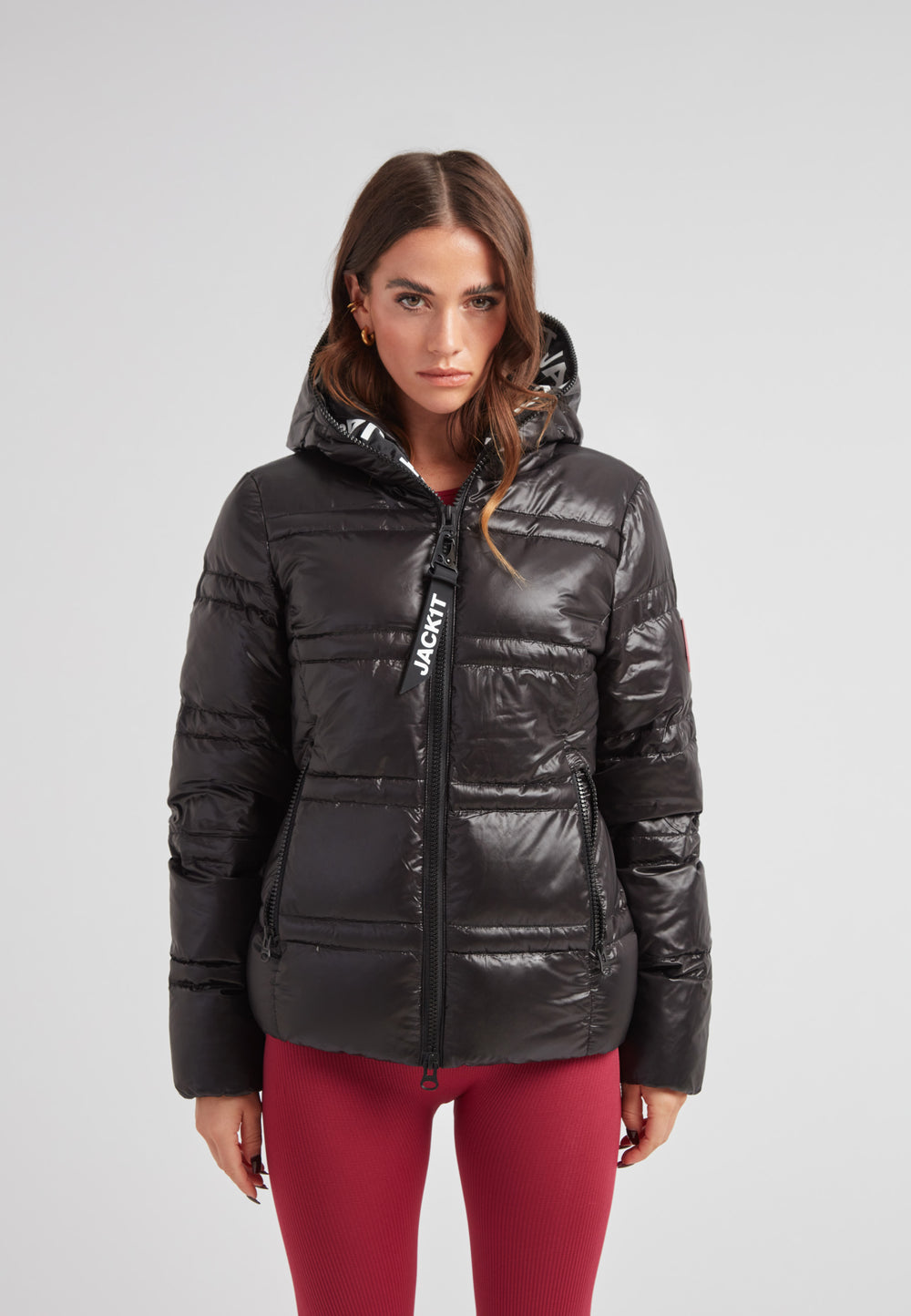 R4D Tramline Puffer Racer Jacket Lux Black worn by model, showcasing its sleek design and hood.