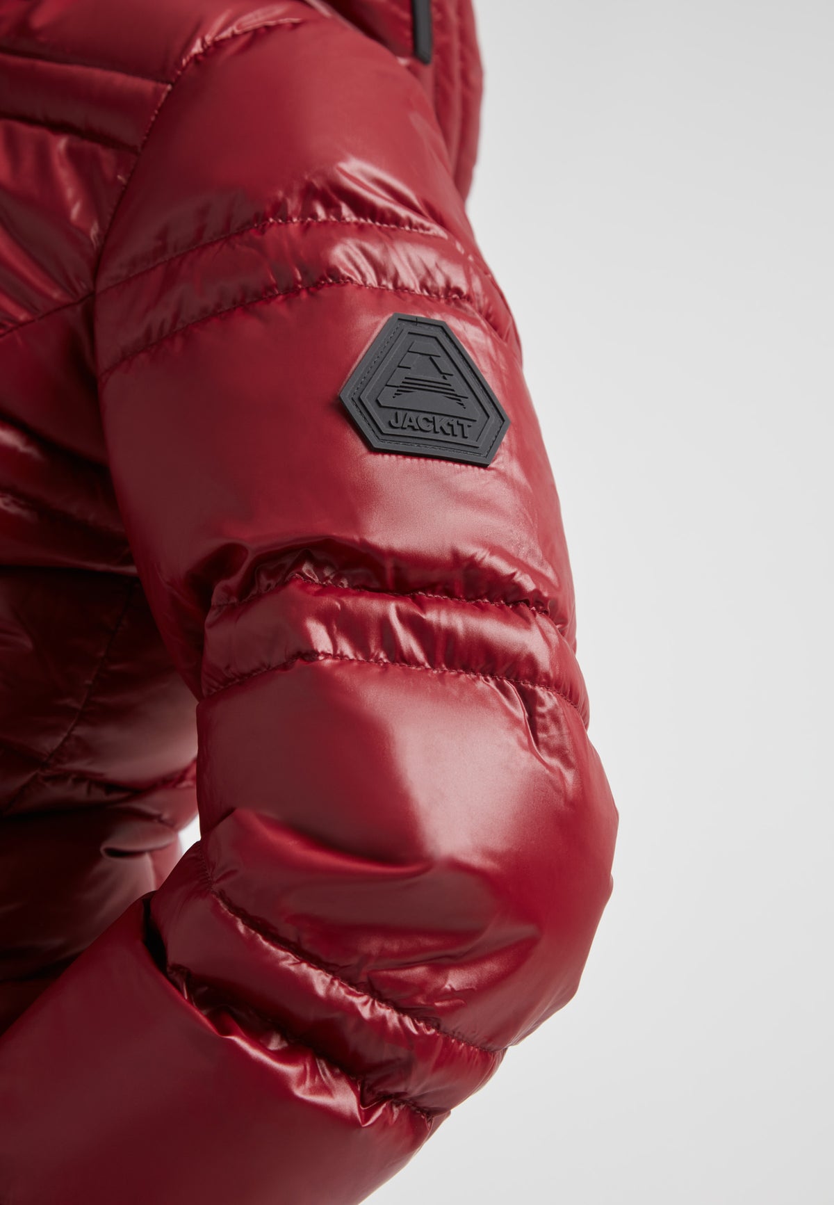 Close-up of the R4D Tramline Puffer Racer Jacket Lux Cranberry showing the sleeve and JACK1T logo.