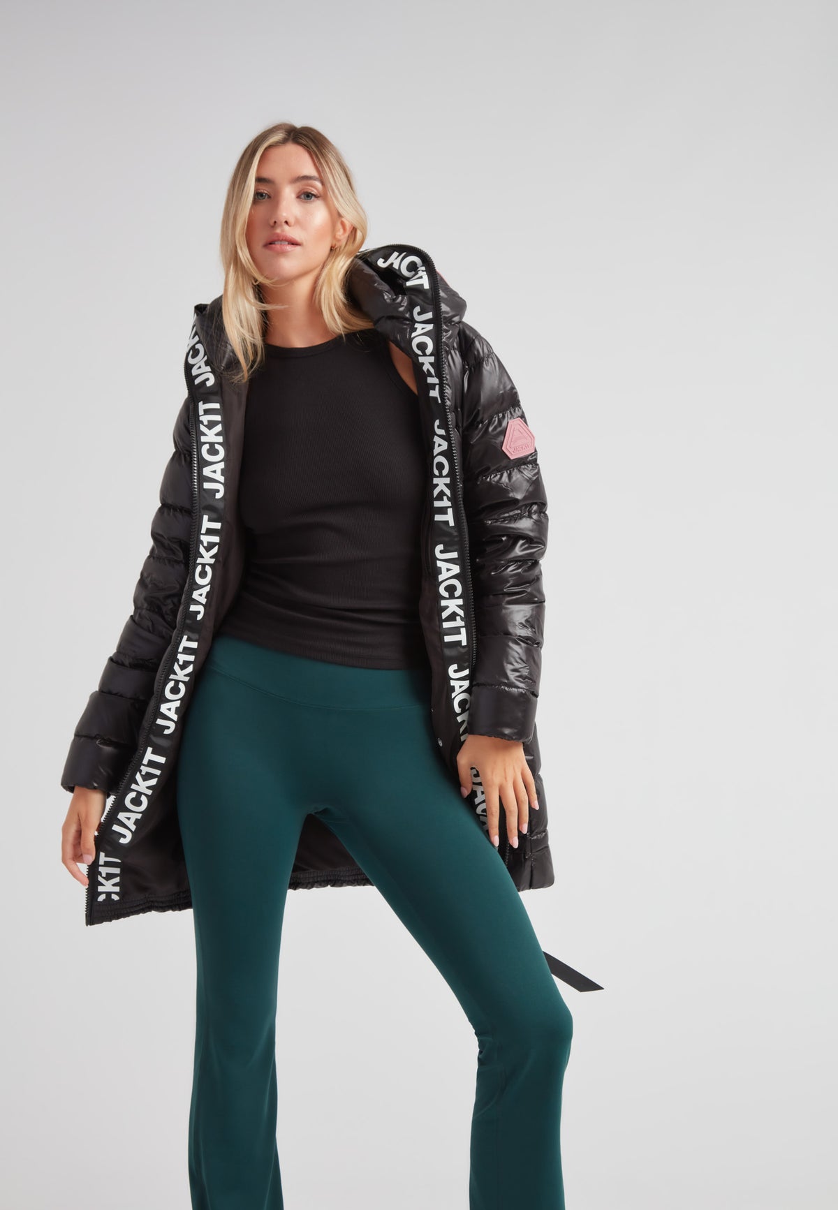 R4D Tramline Down Coat Lux Black worn by a model, featuring a sleek design for cold-weather comfort.