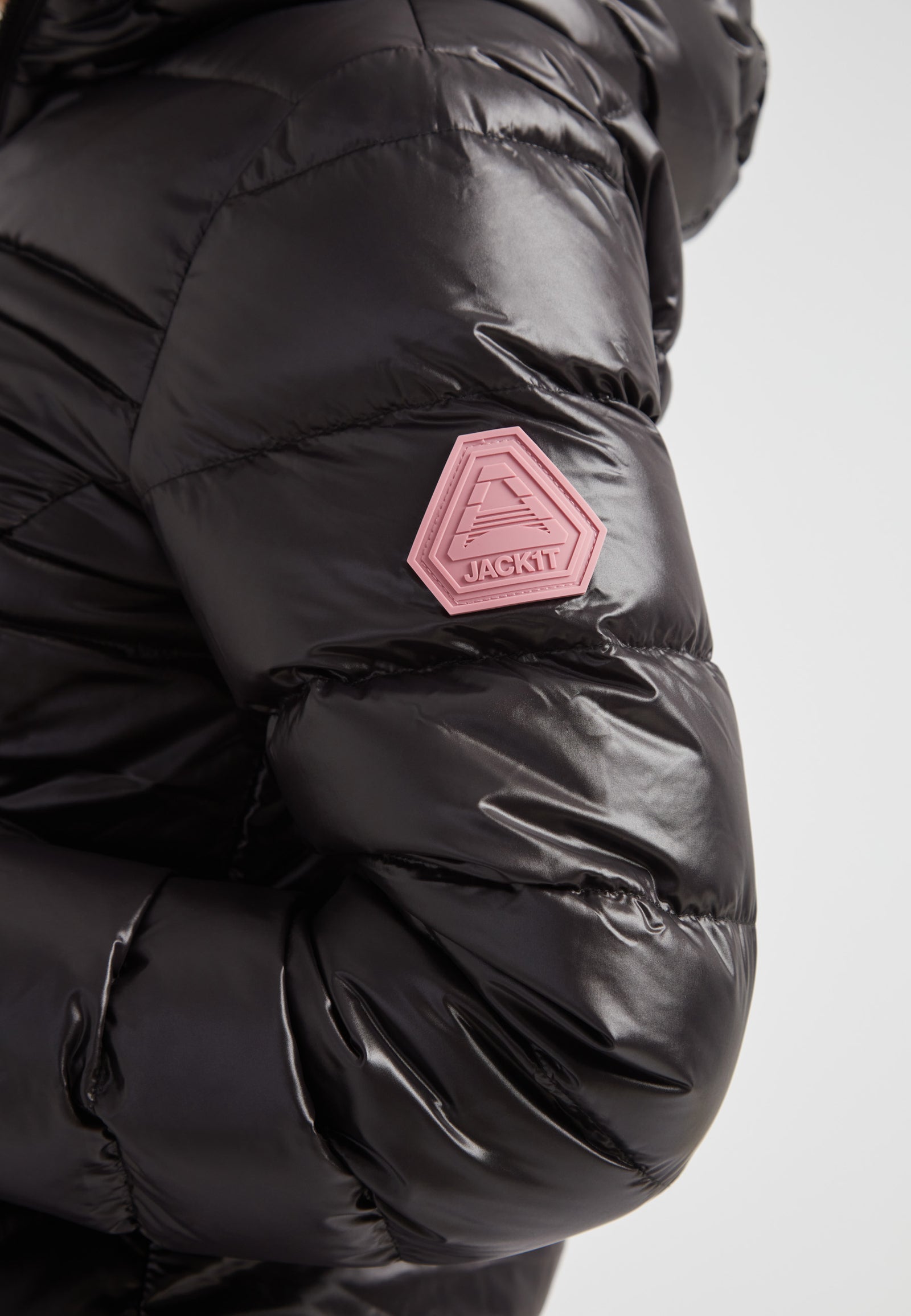 Detail of the R4D Tramline Down Coat Lux Black featuring JACK1T logo on the sleeve and sleek black shell.