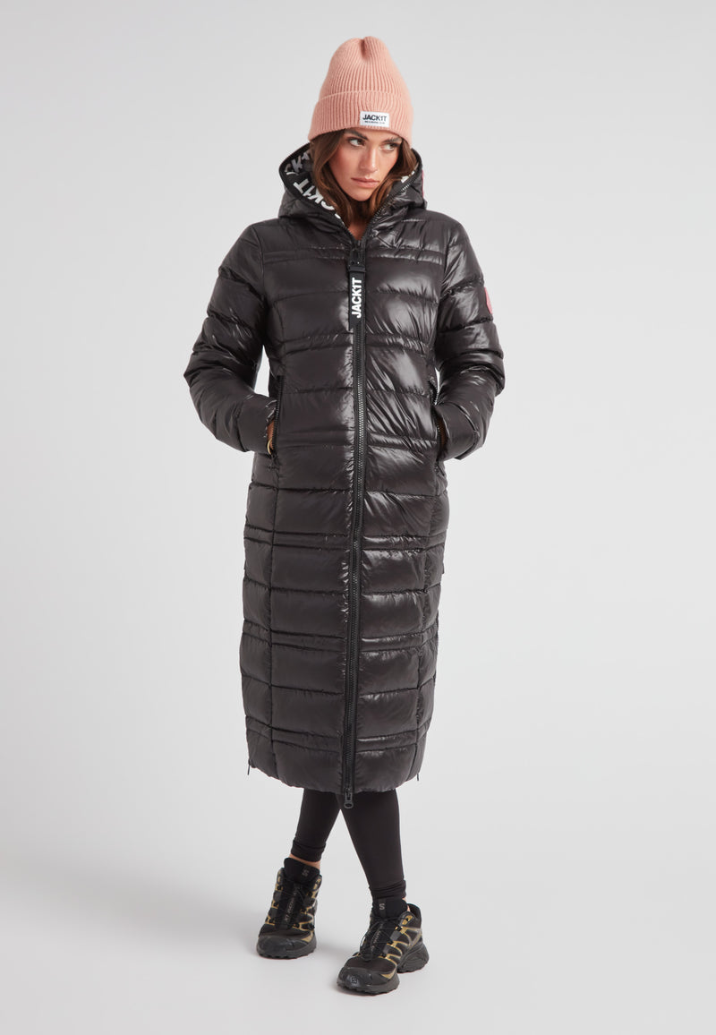 R4D Tramline Extra Long Down Coat Lux Black worn by a model, featuring a fixed hood and water-repellent shell.