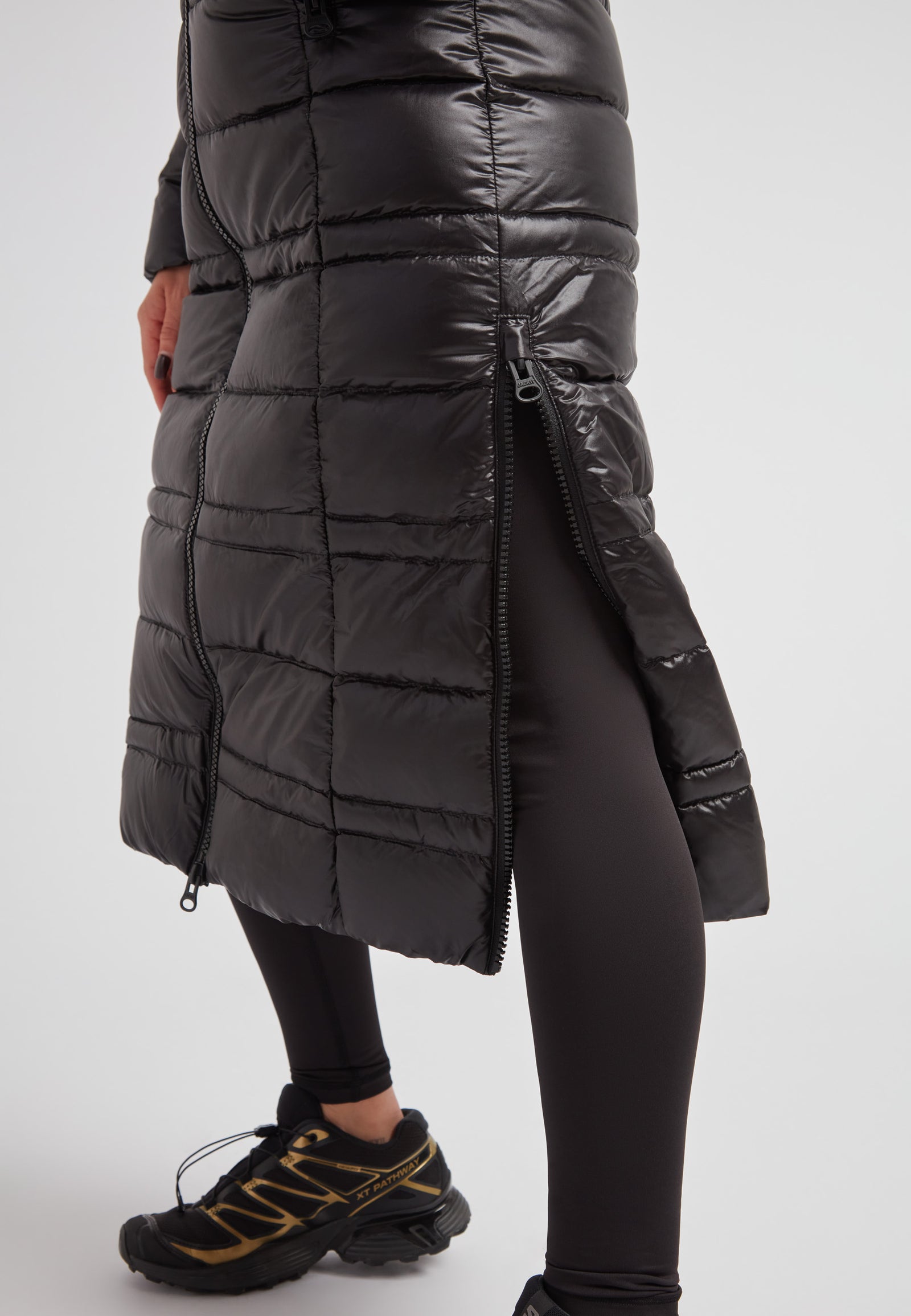 R4D Tramline Extra Long Down Coat Lux Black showcasing side-zip vents and full-length fit with sleek design.
