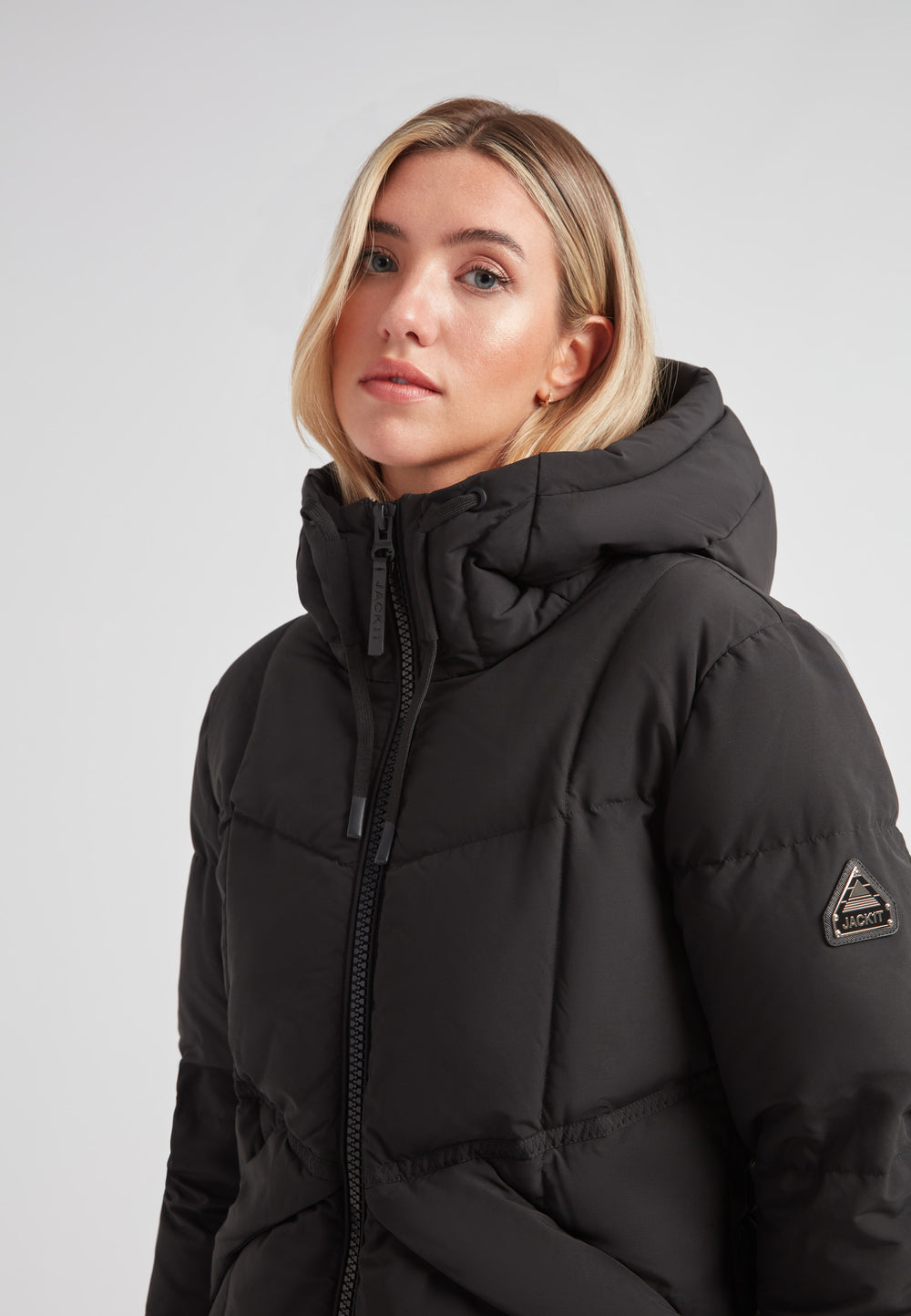 Black Star Puffer Down Coat Black, featuring a hood and sleek design, ideal for cold weather fashion.