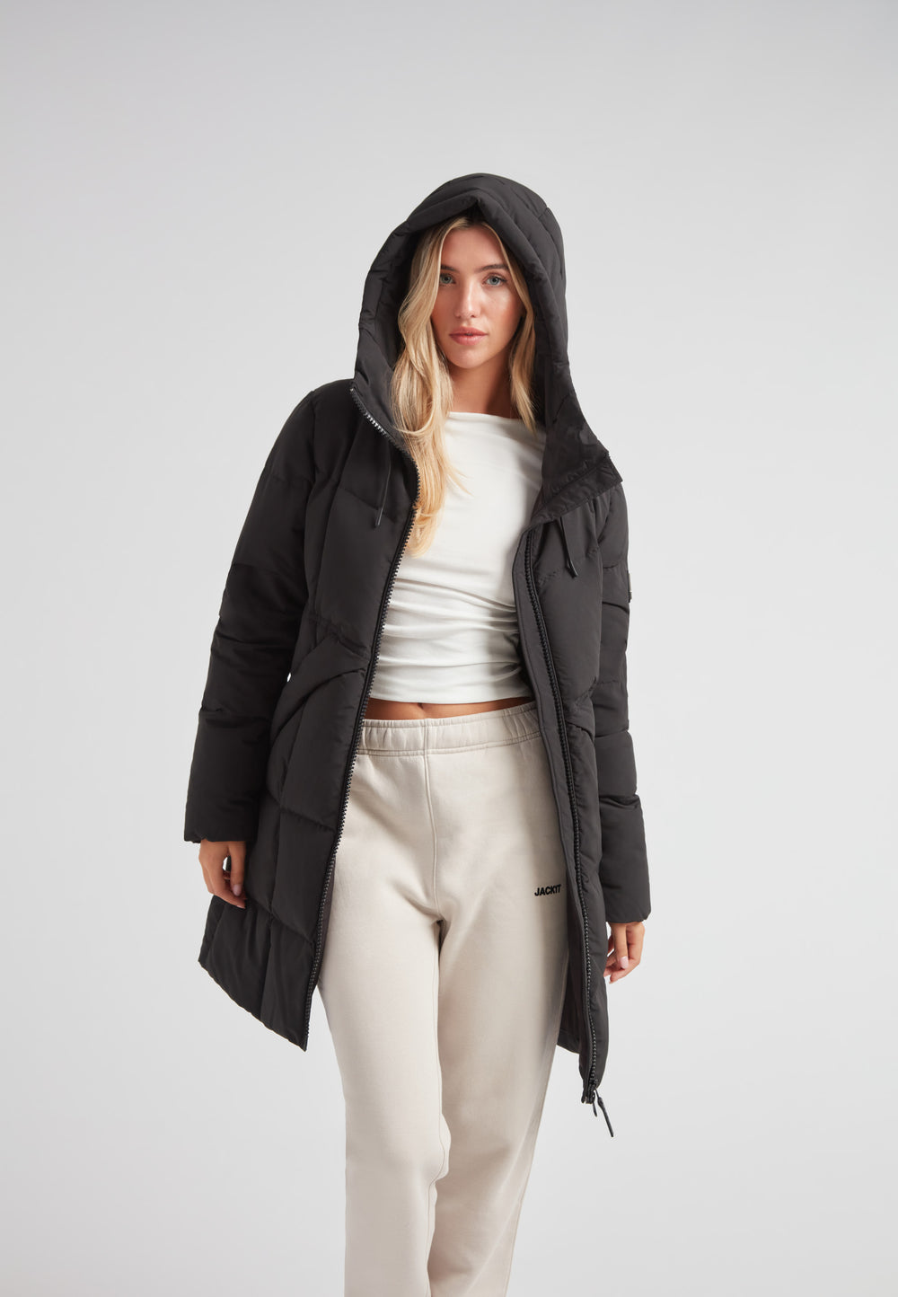 Black Star Puffer Down Coat Black worn by a model, showcasing its stylish design and functional elements.