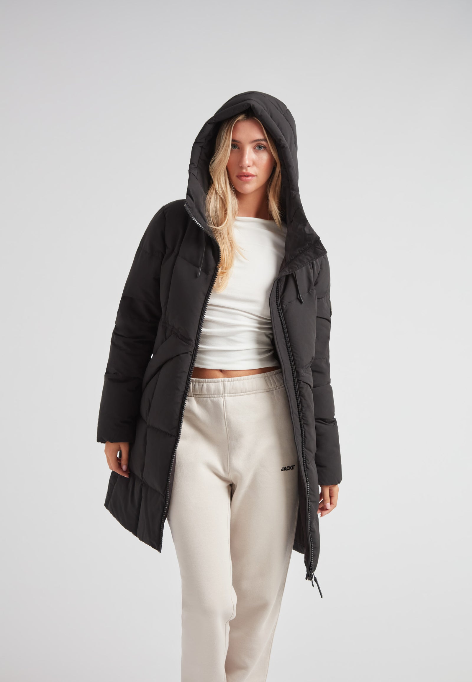 Black Star Puffer Down Coat Black worn by a model, showcasing its stylish design and functional elements.