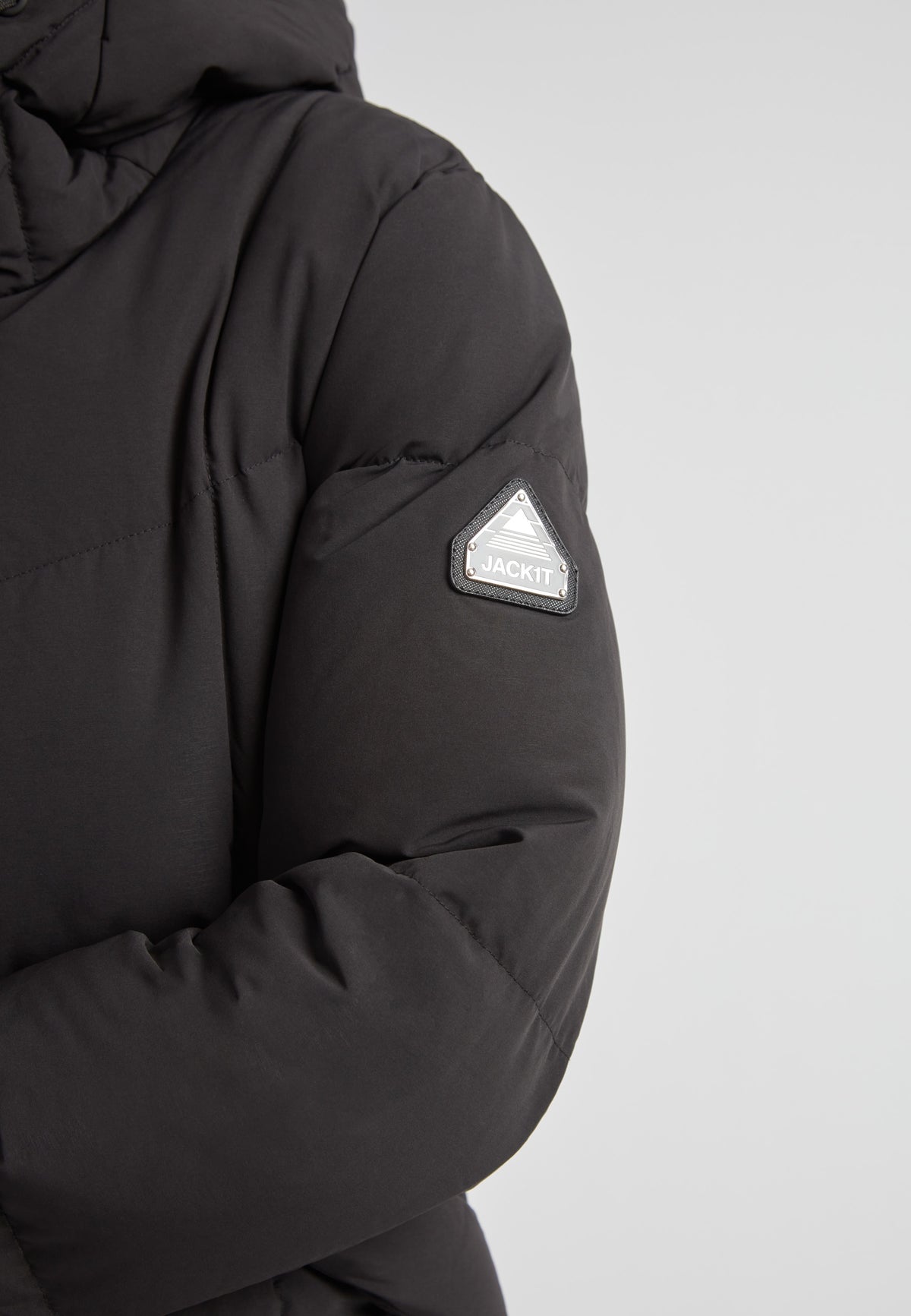 Black Star Puffer Down Coat Black showing sleeve detail and logo on matte black fabric.