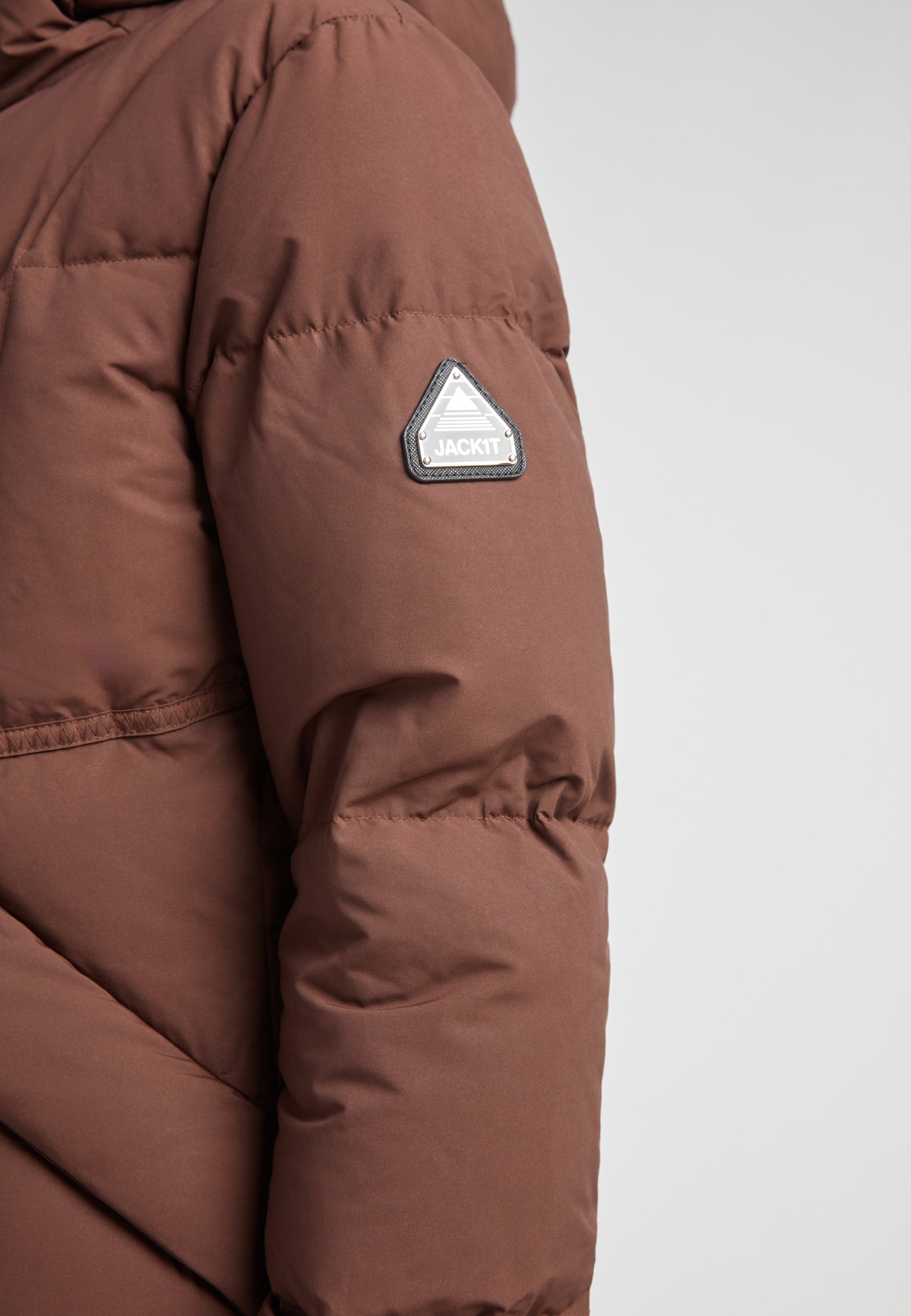 Black Star Extra Long Down Coat Matt Mid Brown close-up of sleeve detail with logo