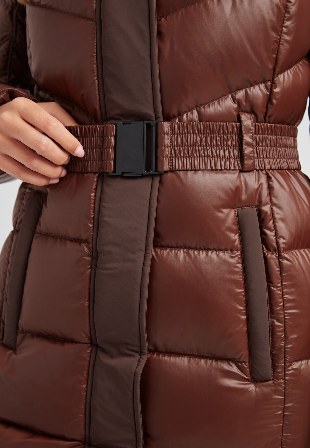 Close-up of the Diamond Belted Extra Long Down Coat with a removable belt, showcasing women's puffer coat with fur hood in brown.