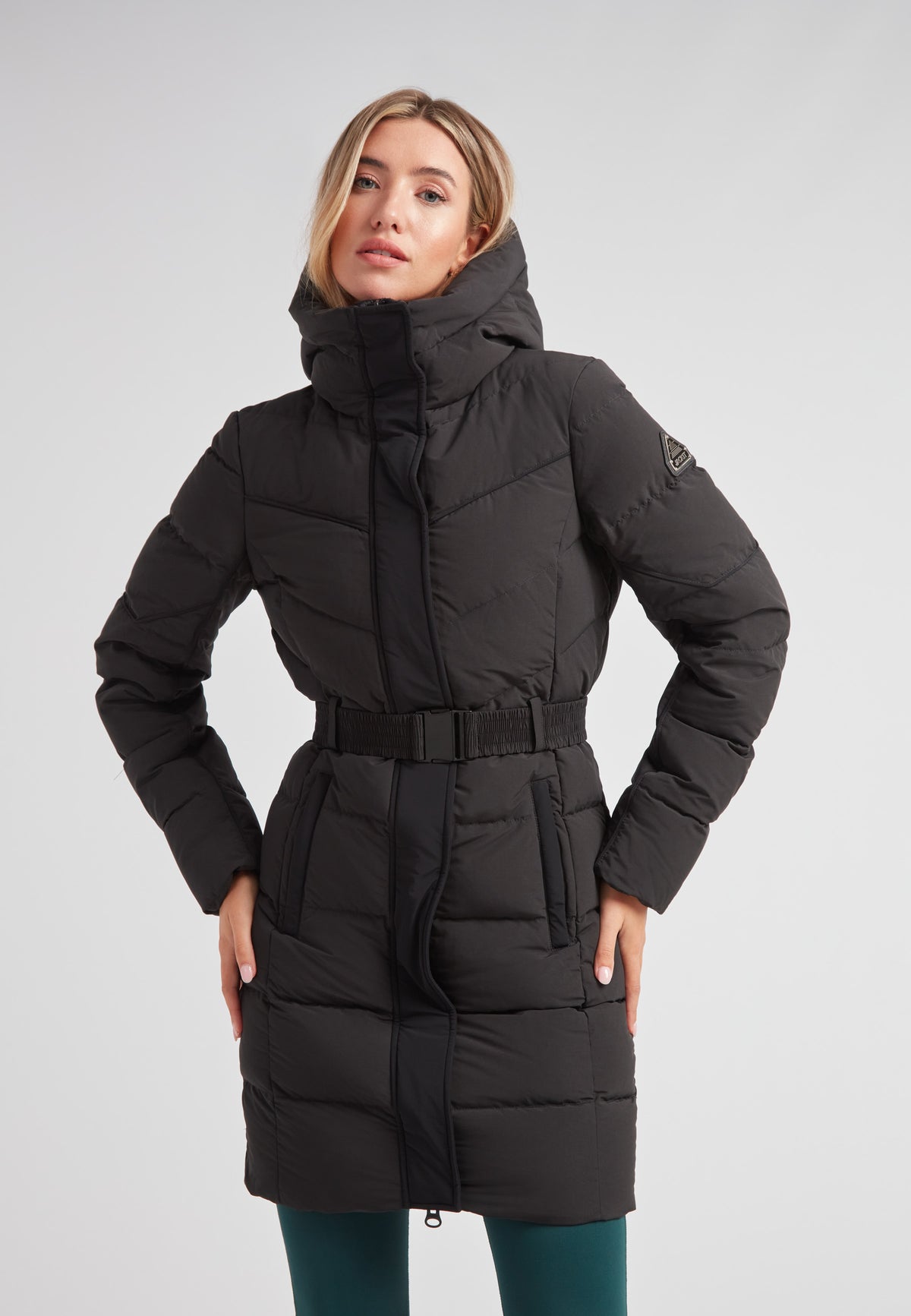 Diamond Belted Down Coat Matt Black worn by a woman, featuring a stylish design and cozy insulation for winter.