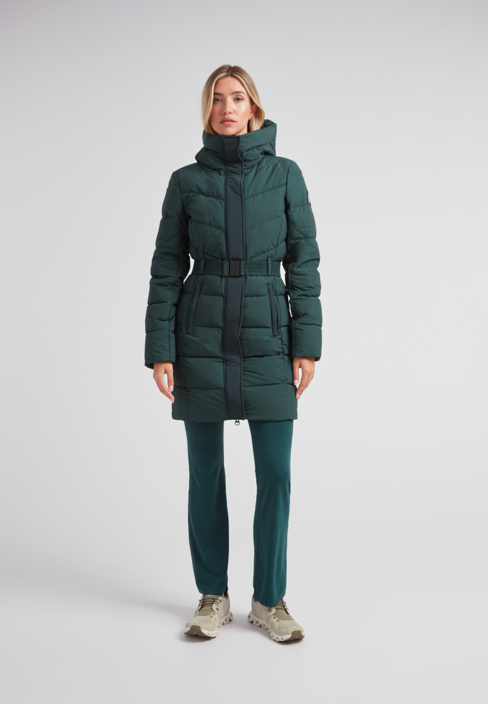 Diamond Belted Down Coat Matt Emerald worn by a model, showcasing a sophisticated winter style.