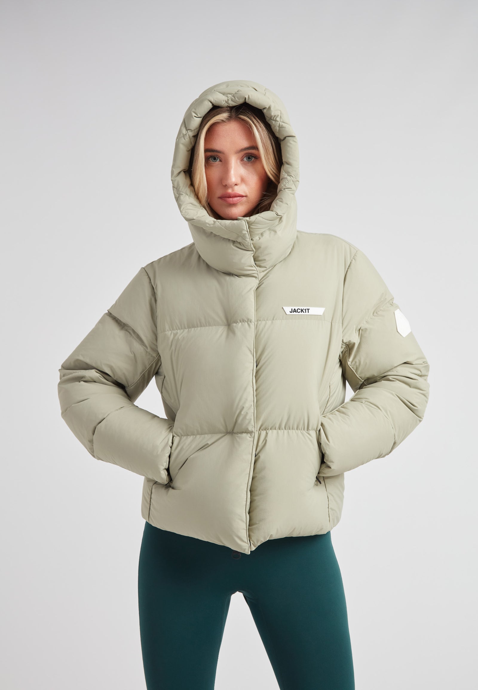 Star Shower Down Puffer Jacket Sage in soft green color, perfect for cold-season fashion and outdoor activities.